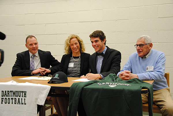 photo of Davis Brief signing a national letter of intent to play football at Dartmouth College. 