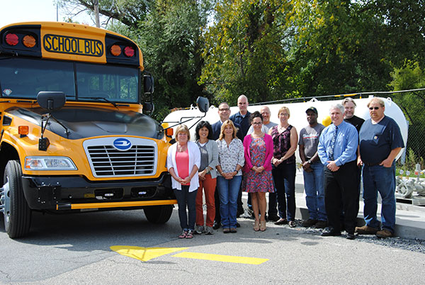 Superintendent Dr. David Leach, Director of Human Resources Mrs. Cindy Leandro, Assistant Superintendent for Business Mr. Timothy Holmes, Director of Transportation Ms. Debra Weissman and members of the Transportation Department stand next to one of the District's new propane buses.
