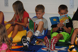 photo of students reading books in the classroom