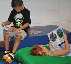 photo of students sitting and lying down while reading