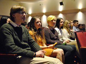 A group of students sitting in the front of the auditorium. 