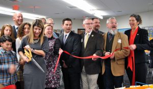 a selection of people cutting a ribbon