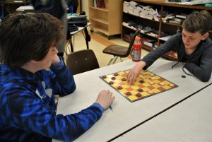 Two students playing checkers