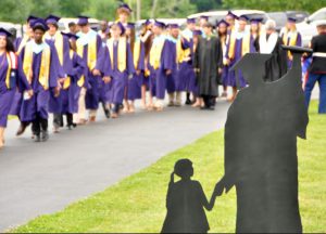 Graduates dressed in caps and gowns walk on sidewalk