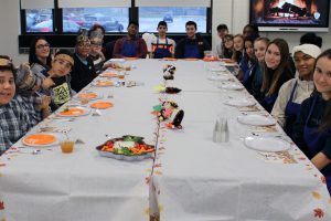 High school’s ‘Taste of Culinary’ class students prepare Thanksgiving meal for a very special middle school class