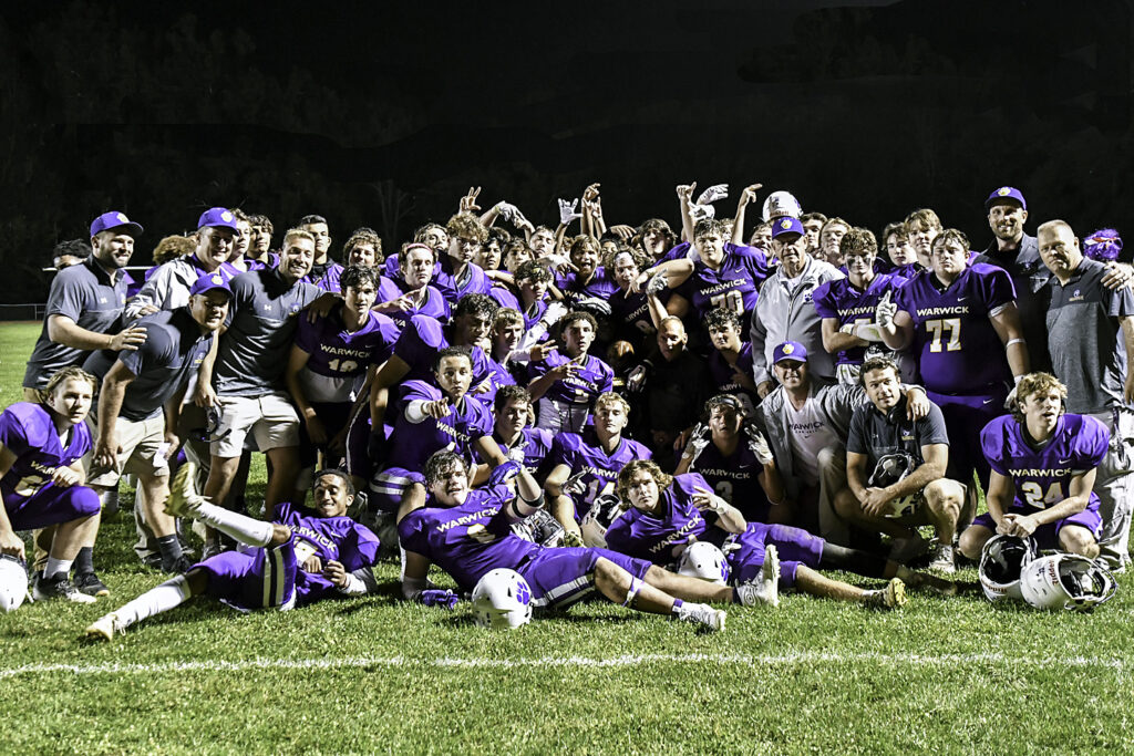 Warwick Varsity Football Celebrates a win over Goshen and retains the Spirit Trophy.