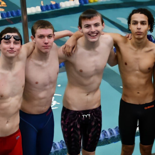 Four warwick swimmers celebrate their victories, poolside.