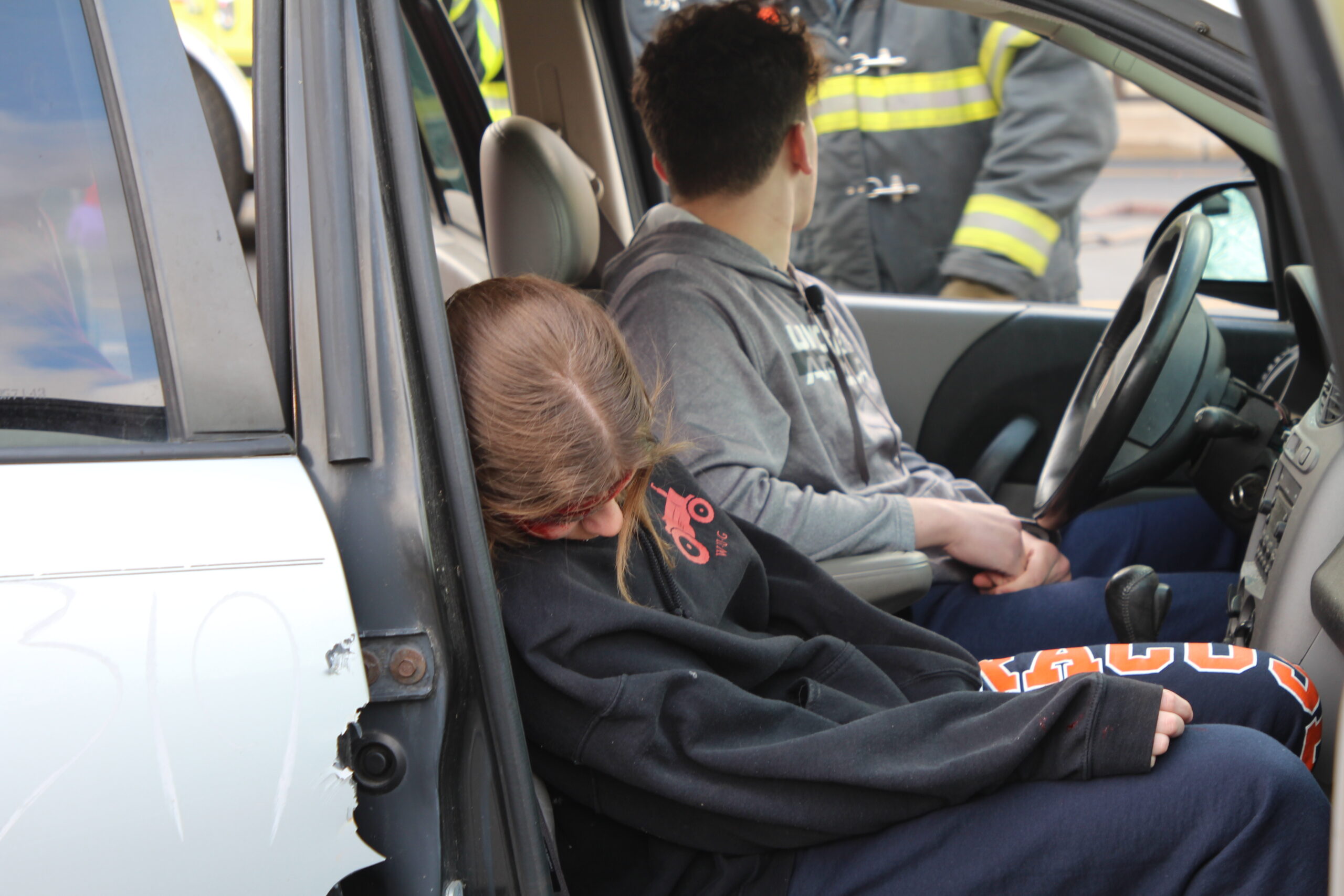 Victims of a mock automobile crash sit in their car at Warwick Valley High School.