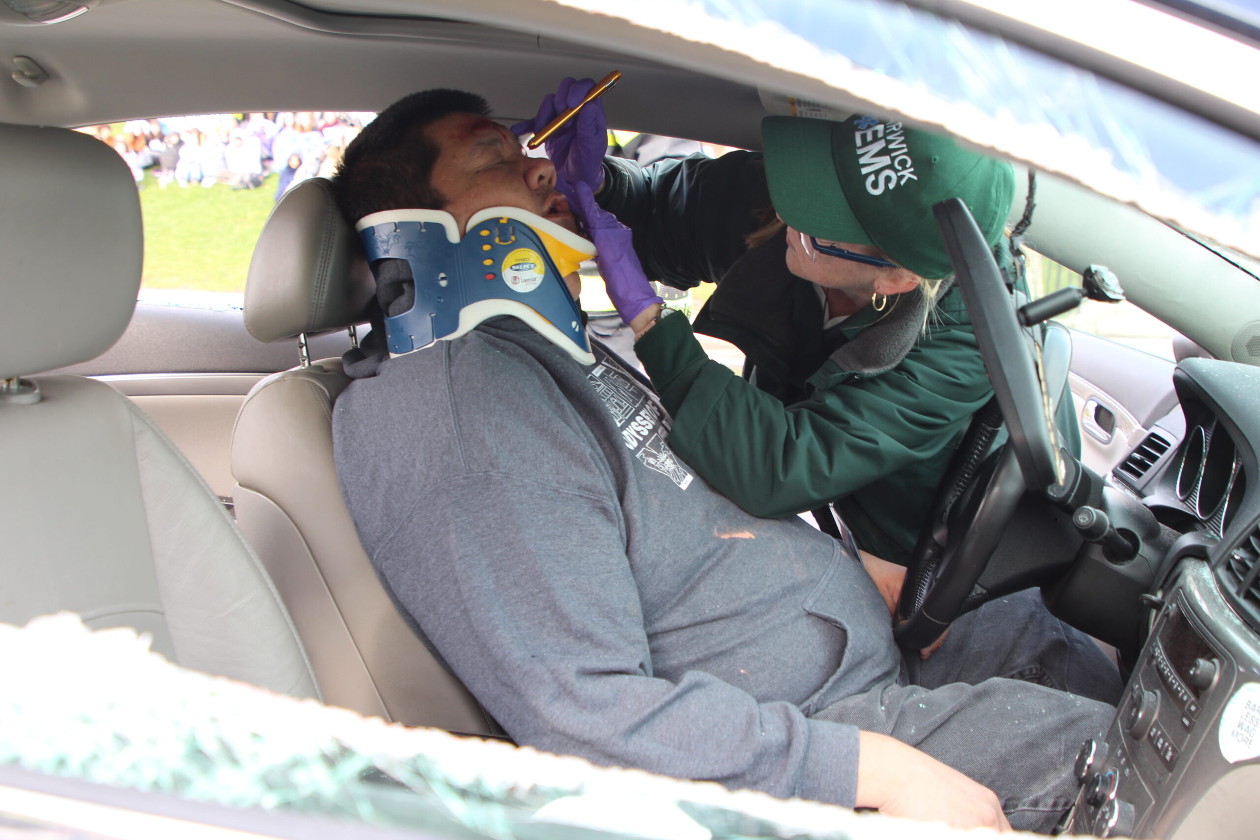 An EM worker examines a victim of a mock automobile crash at Warwick Valley High School.