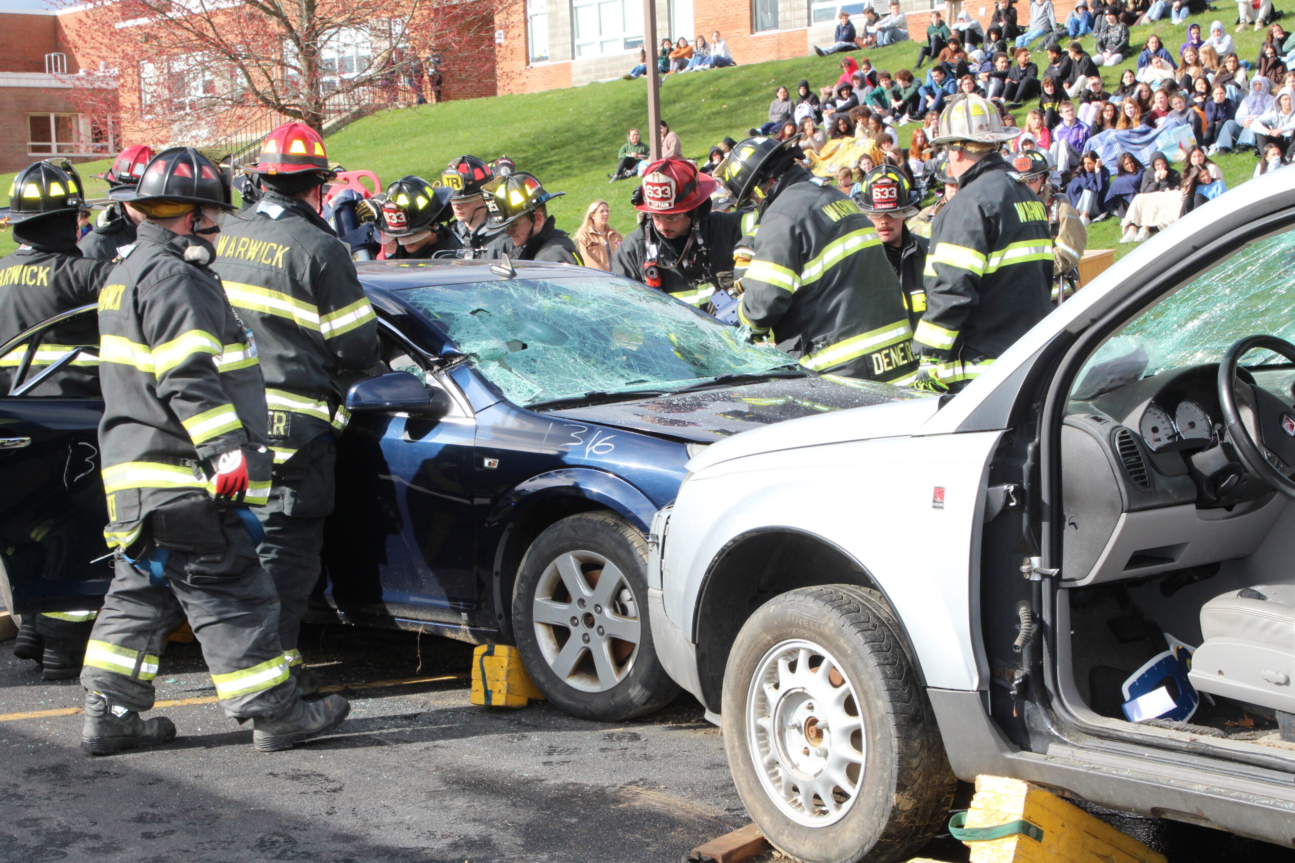 Firefighters and EMS worker aid a victim of a mock automobile crash at Warwick Valley High School.