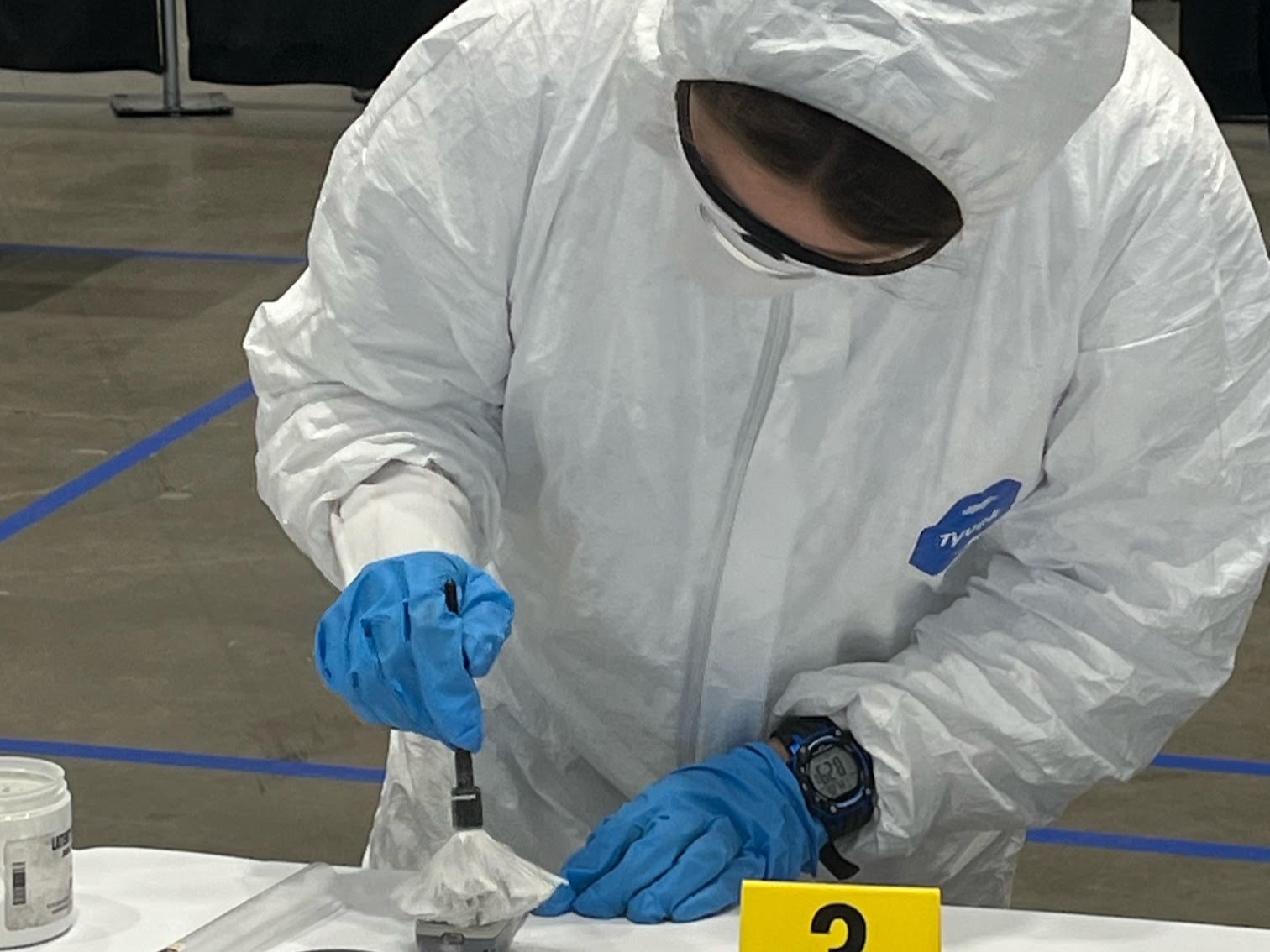 A criminal science student examines evidence during the New York State SkillsUSA competition.