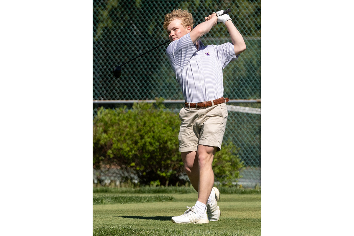 A Warwick Valley High School varsity boys golfer follows through on his drive.