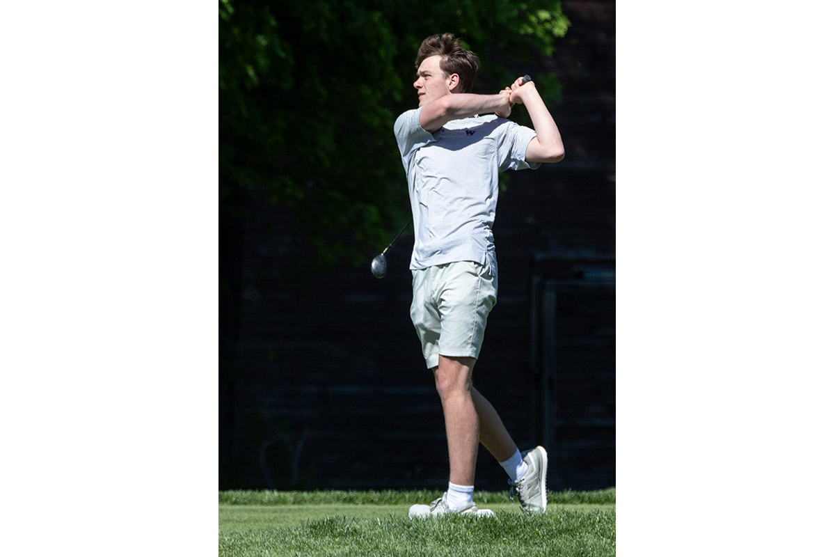 A Warwick Valley High School varsity boys golfer follows through on his drive.