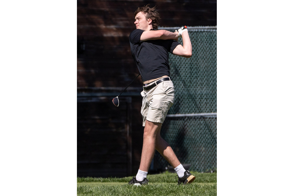 A Warwick Valley High School varsity boys golfer follows through on his drive.