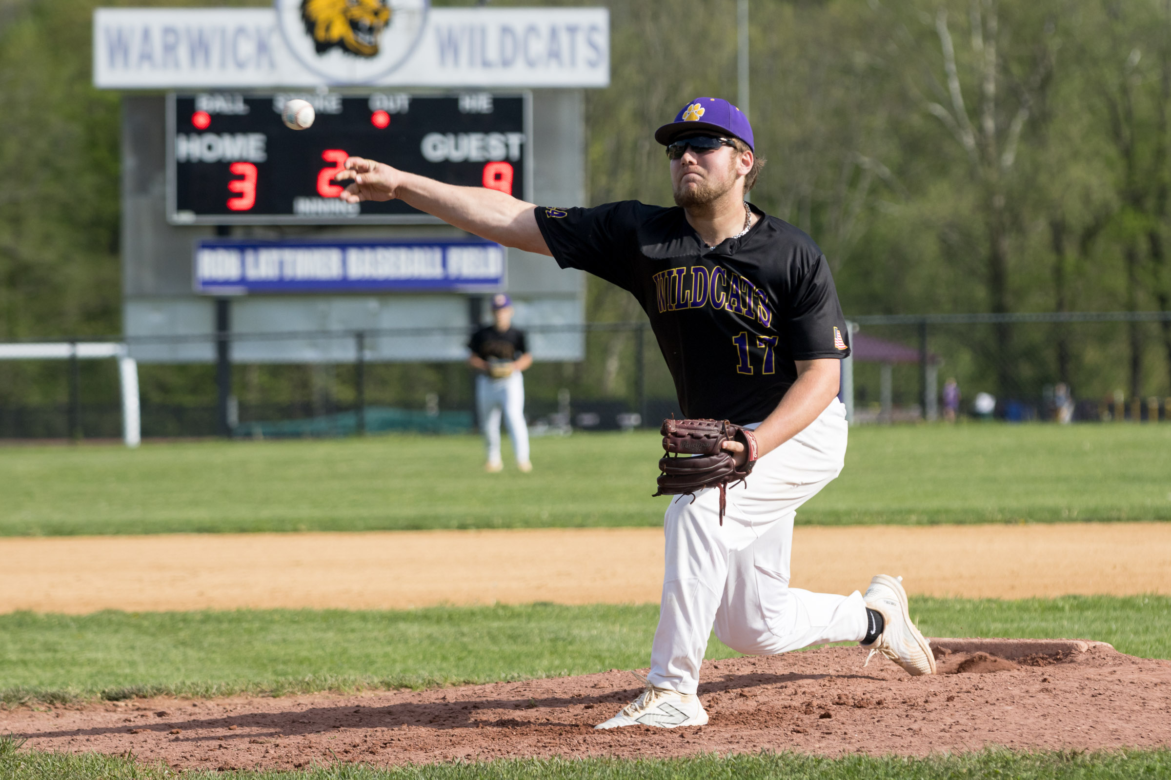 A Warwick Valley High School varsity baseball pitcher throws a pitch.