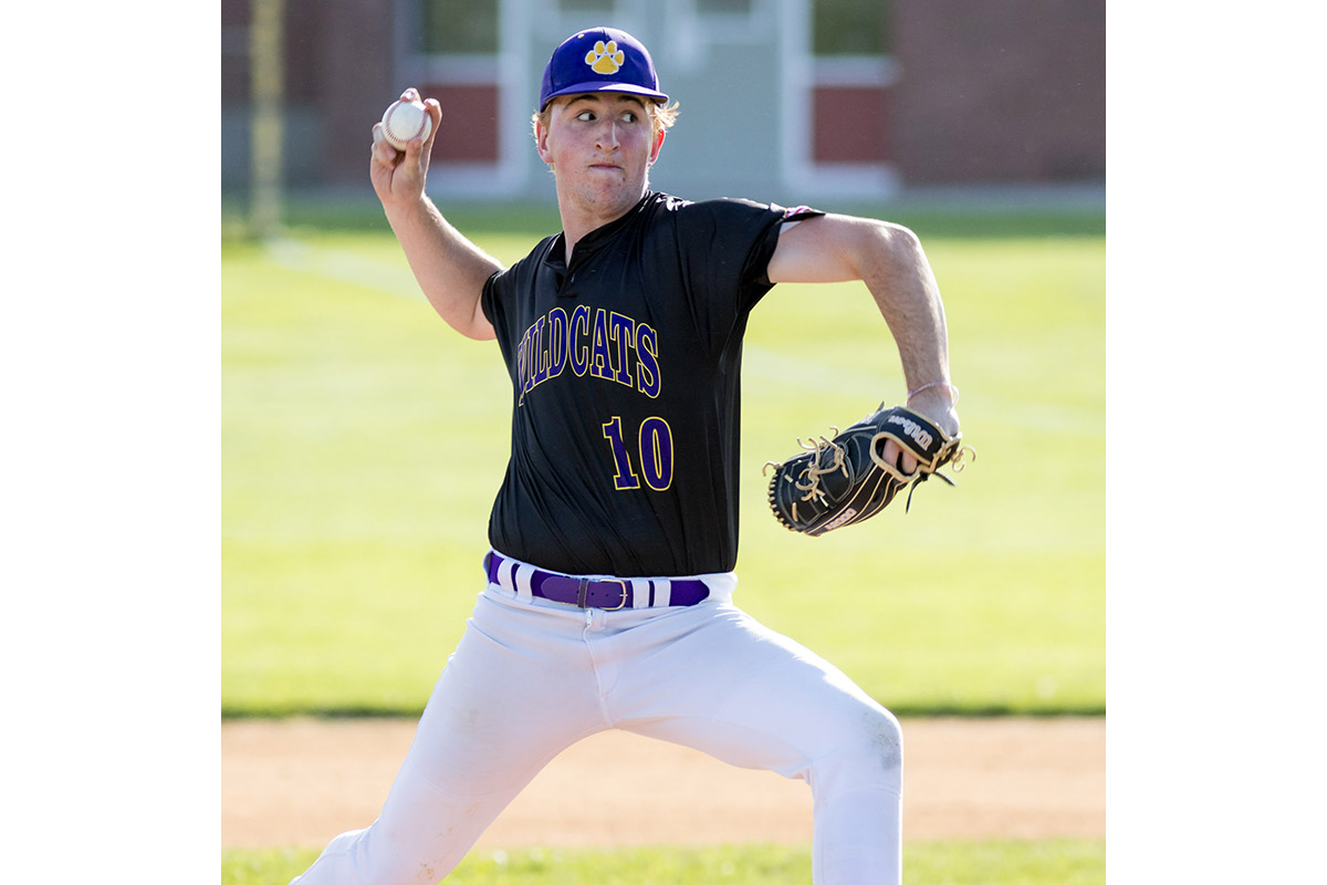 A Warwick Valley High School varsity baseball pitcher winds up.