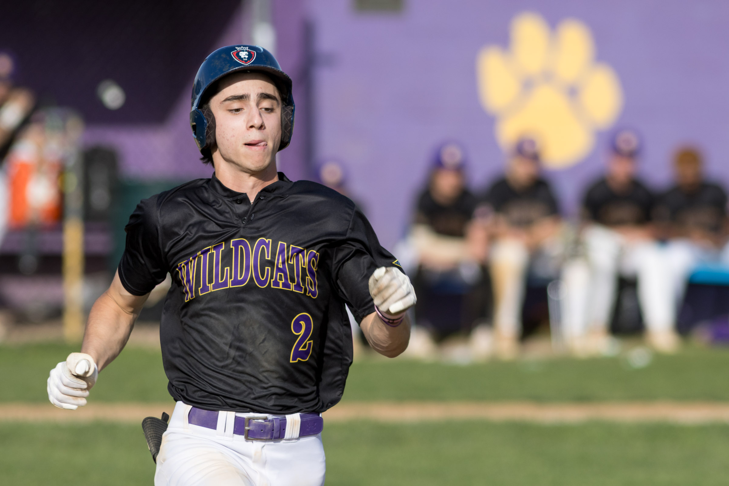 A Warwick Valley High School varsity baseball player runs throw to first base.