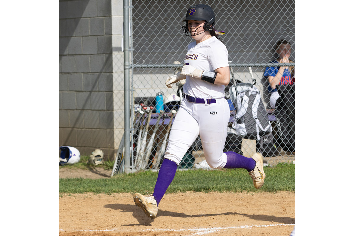 A Warwick Valley High School varsity softball baserunner heads for home plate to score a run.