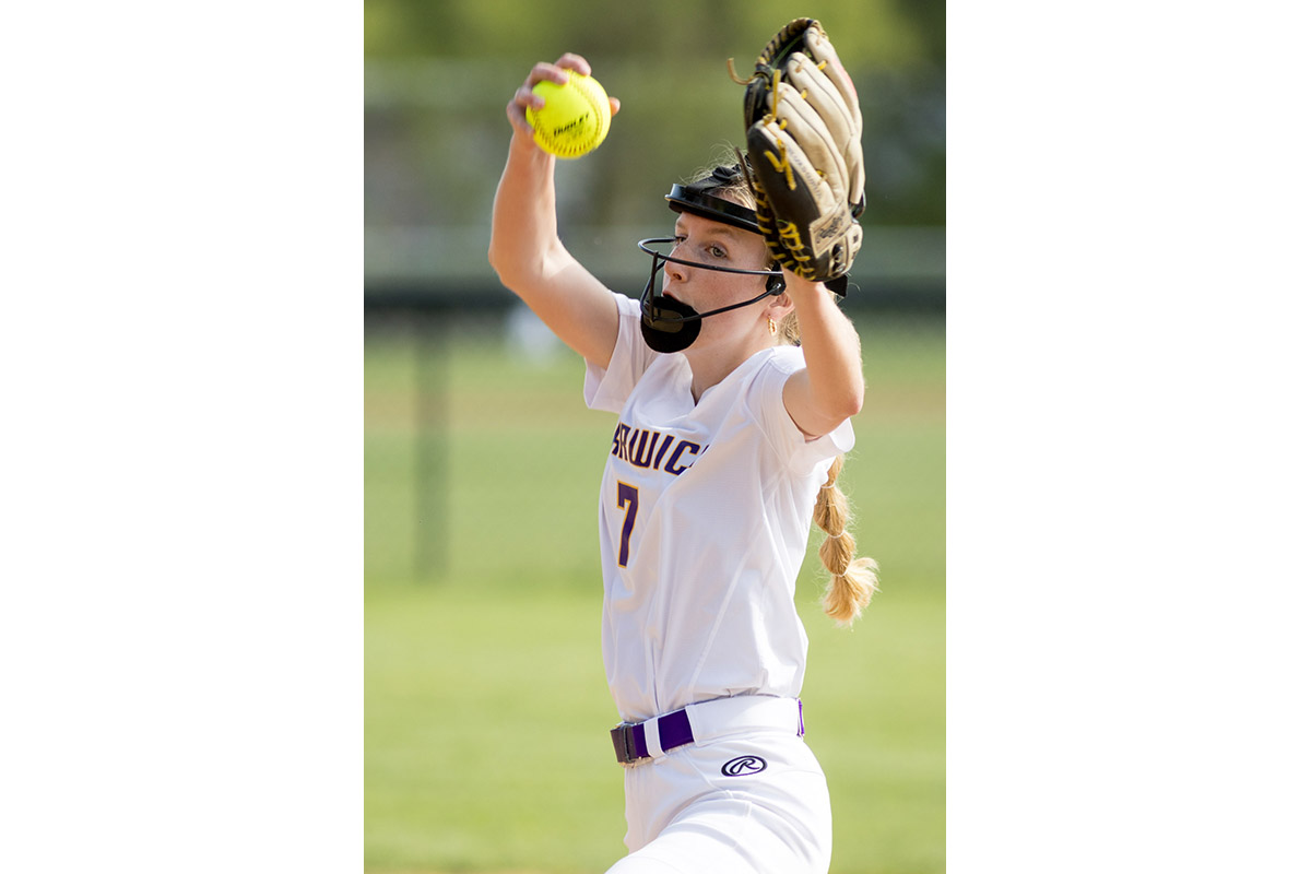 A Warwick Valley High School varsity softball pitcher winds up.