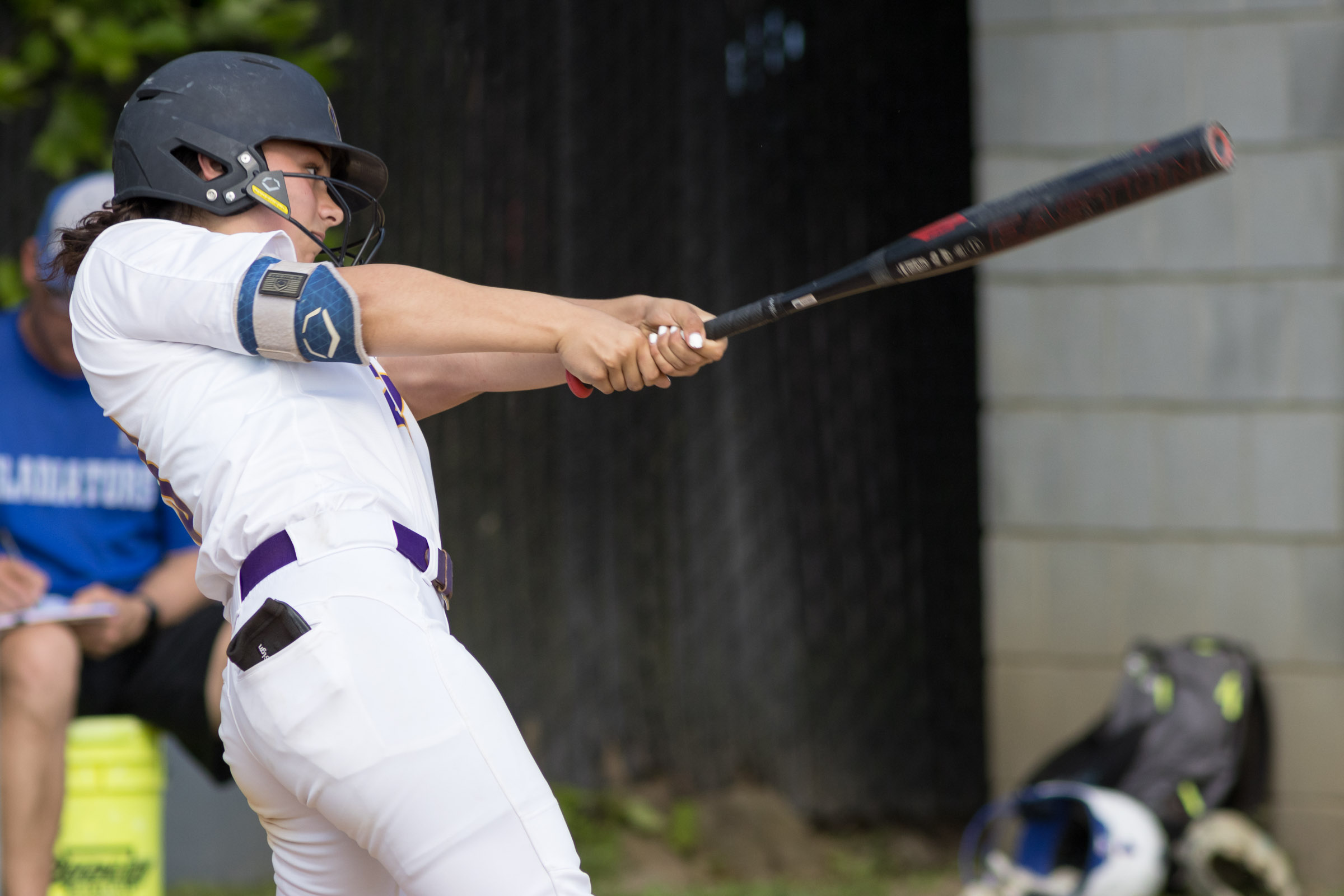 A Warwick Valley High School varsity softball batter follows through on her swing.