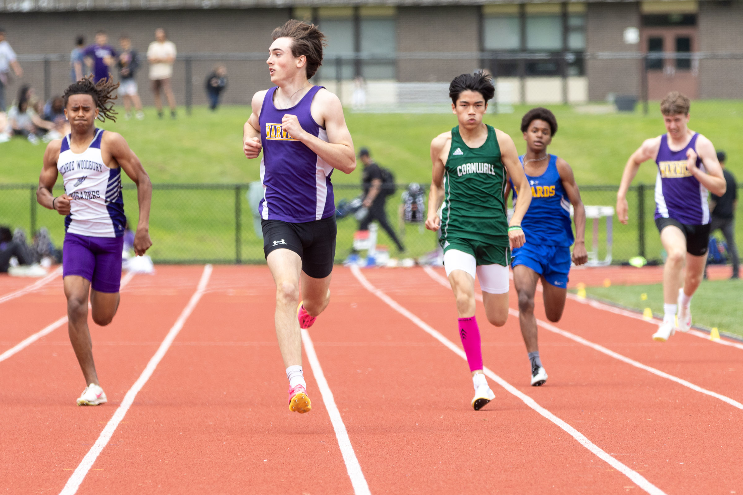 Athletes sprint to the finish line on day one of the OCIAA track and field championship meet at Tim St. Lawrence track.