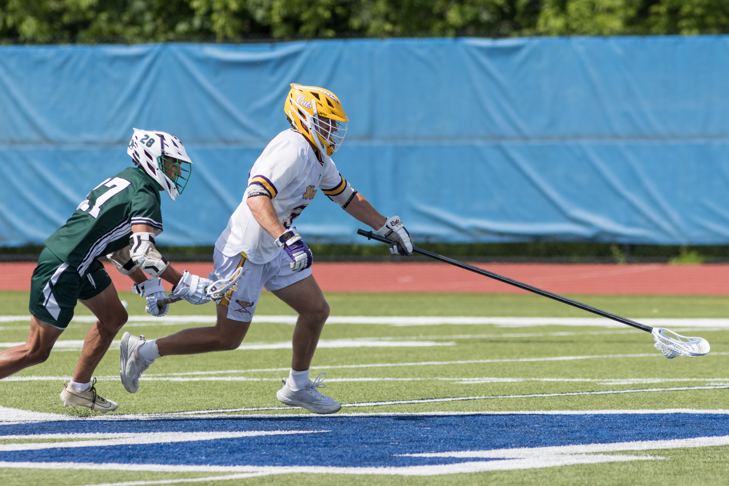 A Warwick Valley varsity boys lacrosse player carries the ball past a Minisink Valley player during the Section 9 Class B championship game.