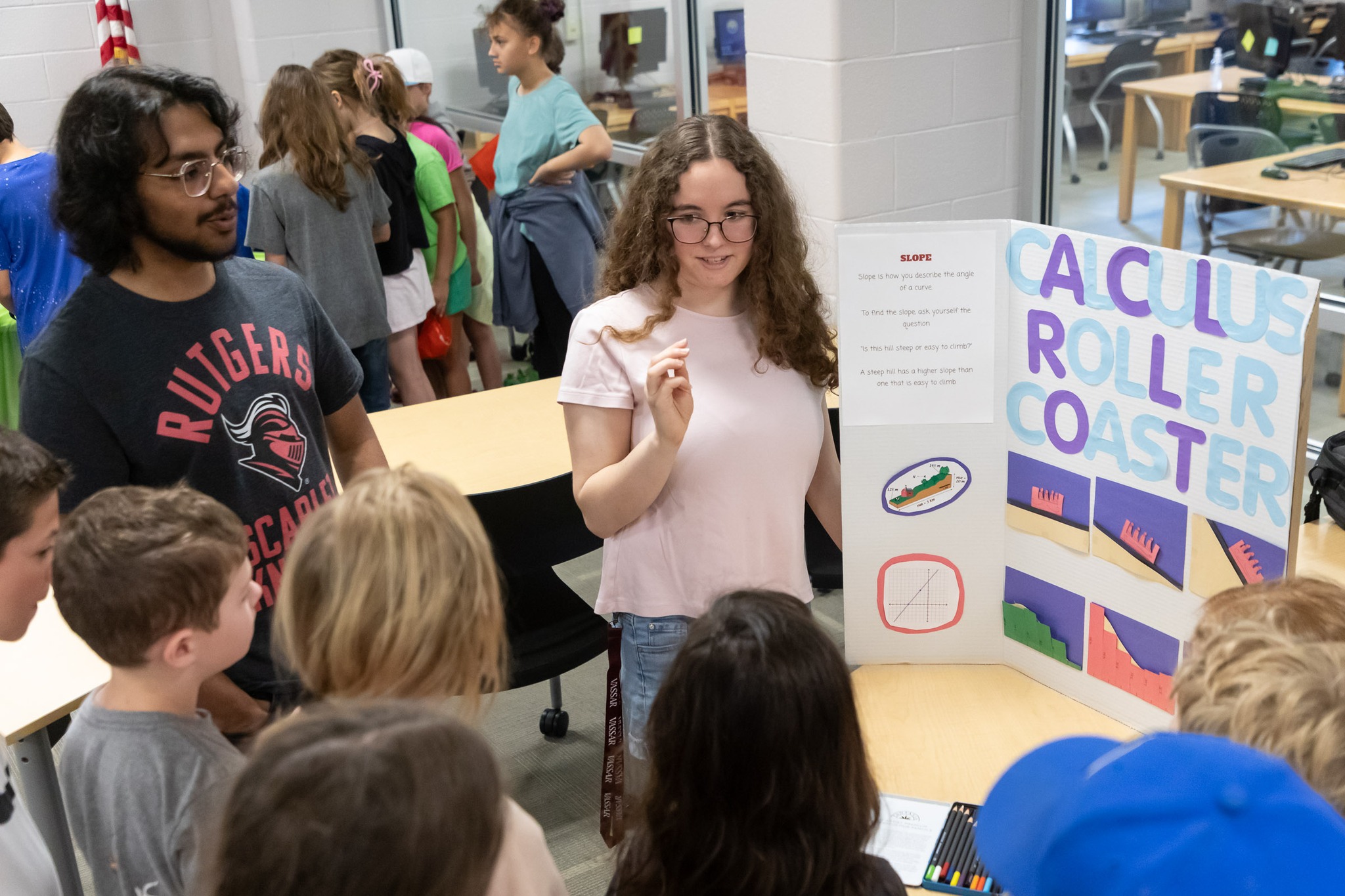 Warwick Valley High School AP calculus class members talk to Sanfordville Elementary School PIE 3-4 students about STEM projects.