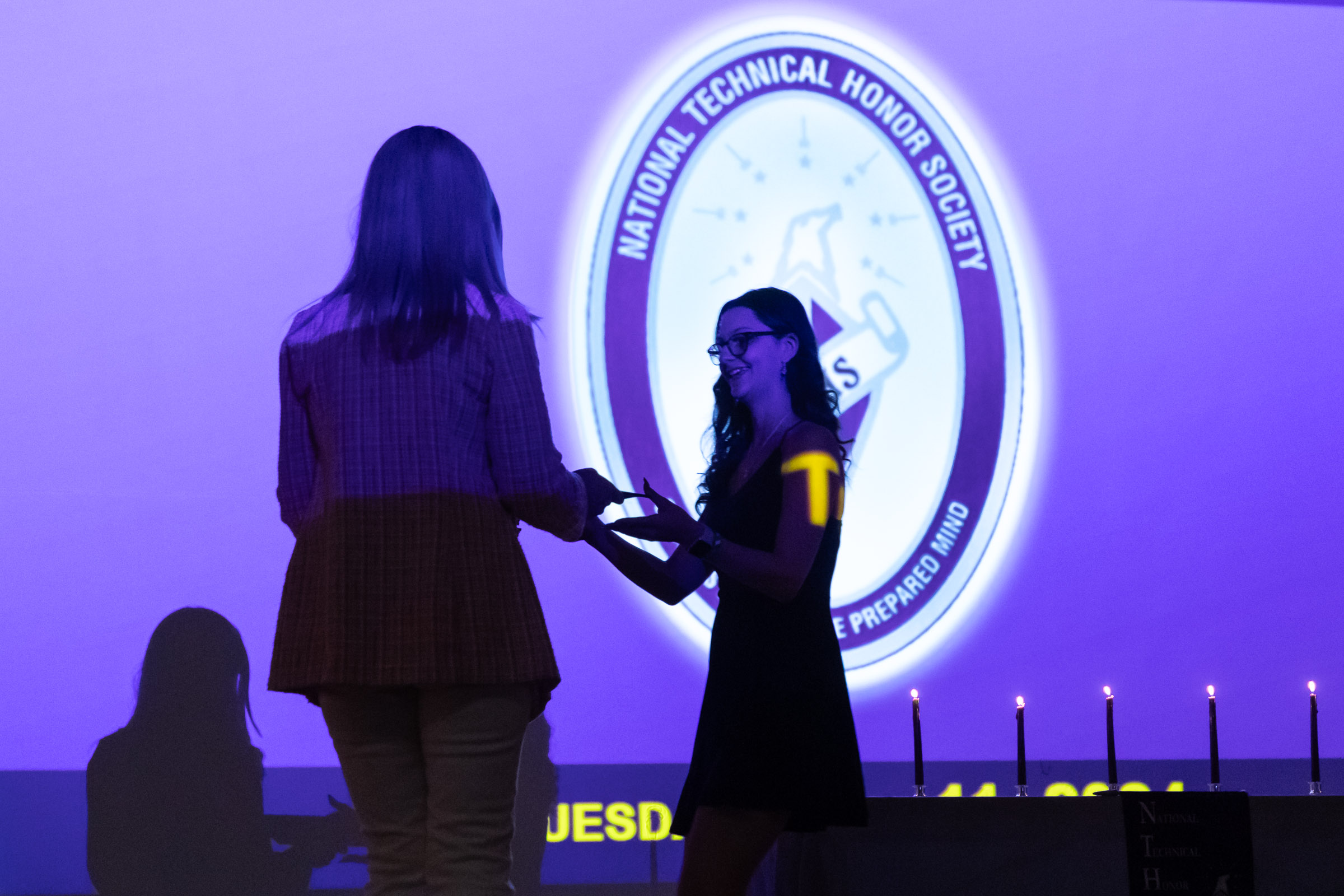 A students get her NTHS certificate from a teacher on stage during the Warwick Valley High School Career and Technical Education Recognition Ceremony and Honor Society Induction