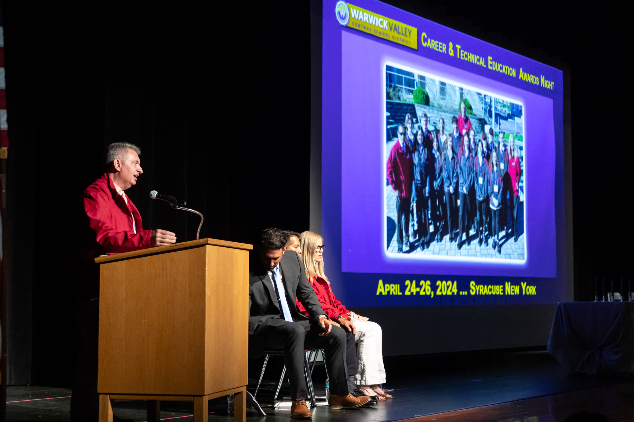 A teacher speaks at the podium during the Warwick Valley High School Career and Technical Education Recognition Ceremony and Honor Society Induction