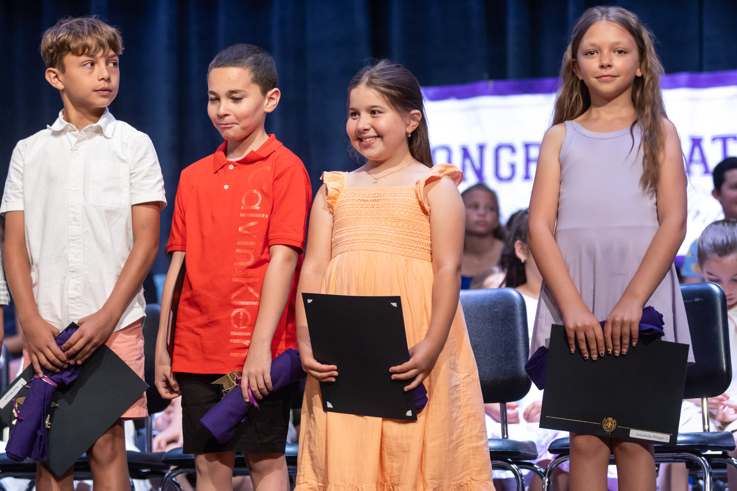 Students smile on stage during the Park Avenue Elementary School Fourth Grade Moving Up Ceremony in the WVHS auditorium