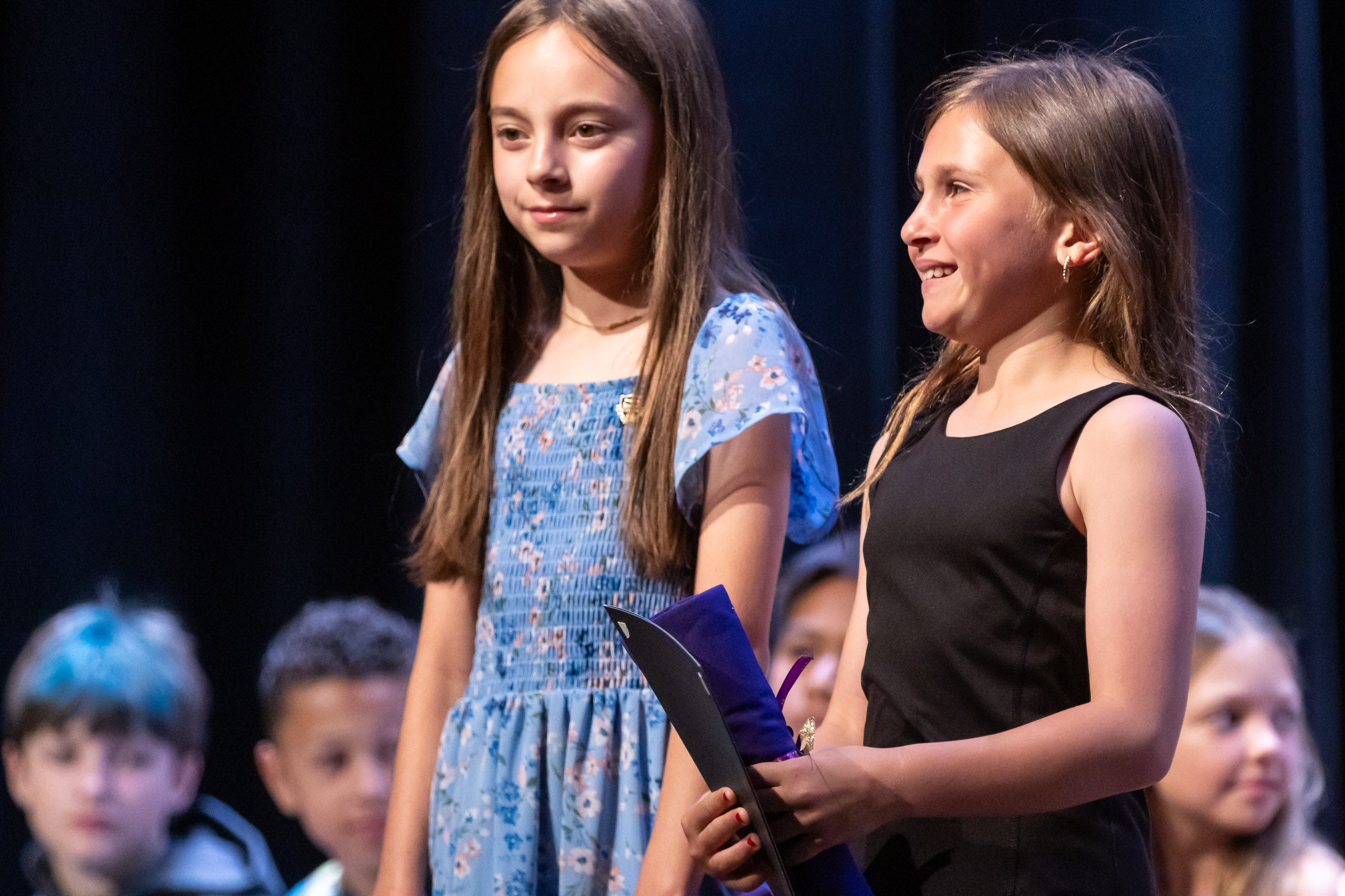 Students smile on stage during the Park Avenue Elementary School Fourth Grade Moving Up Ceremony in the WVHS auditorium