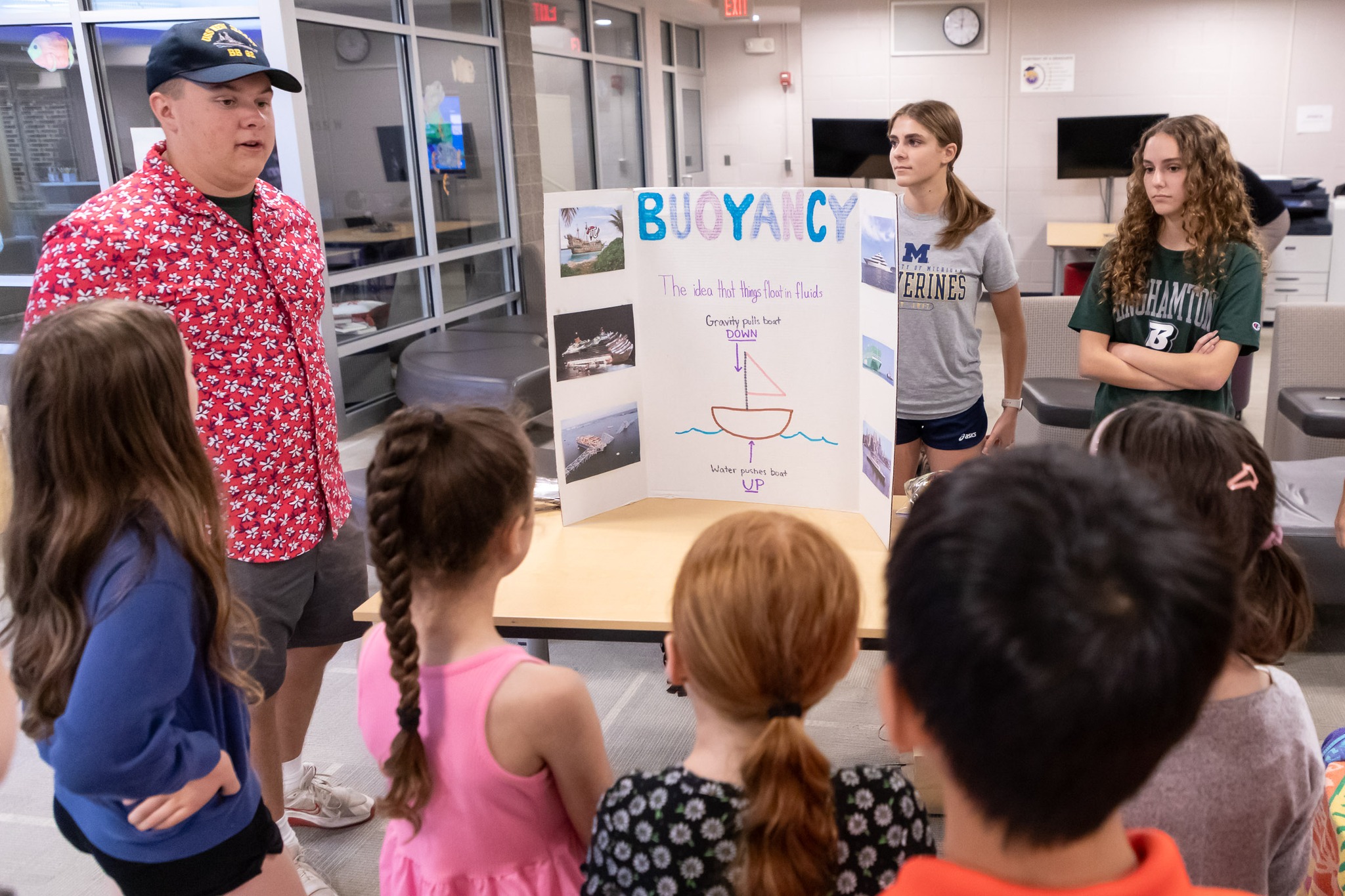 Warwick Valley High School AP calculus class members talk to Sanfordville Elementary School PIE 3-4 students about STEM projects.