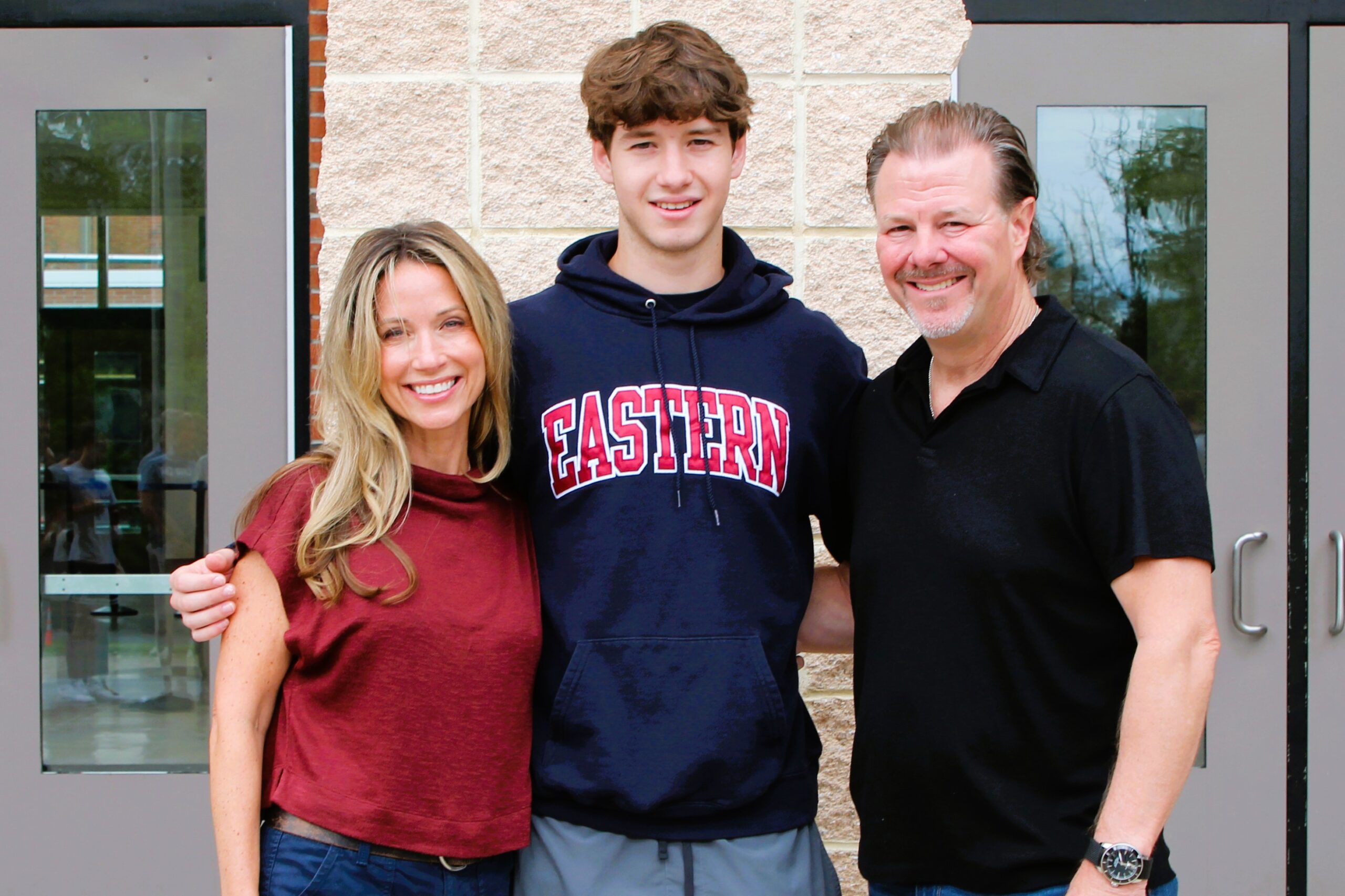 Warwick Valley High School athlete poses with family members after signing a national letters of intent to play sports in college.