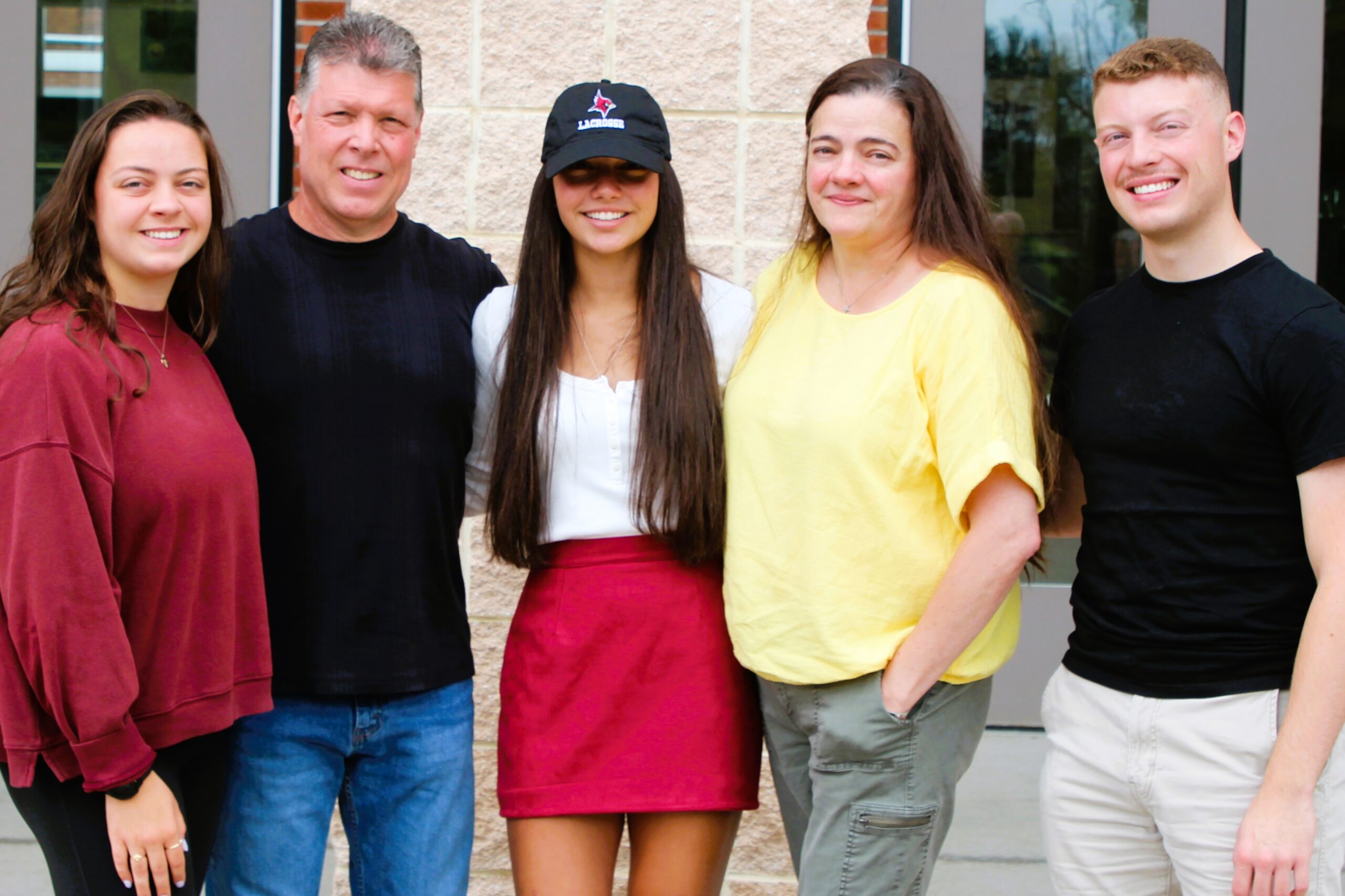 Warwick Valley High School athlete poses with family members after signing a national letters of intent to play sports in college.