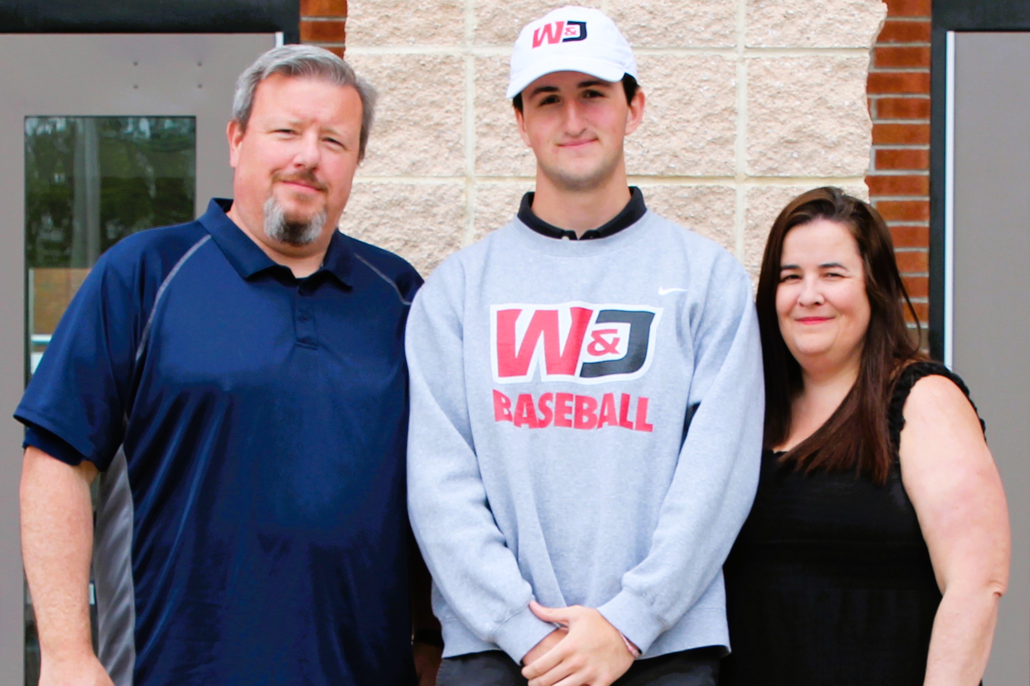 Warwick Valley High School athlete poses with family members after signing a national letters of intent to play sports in college.