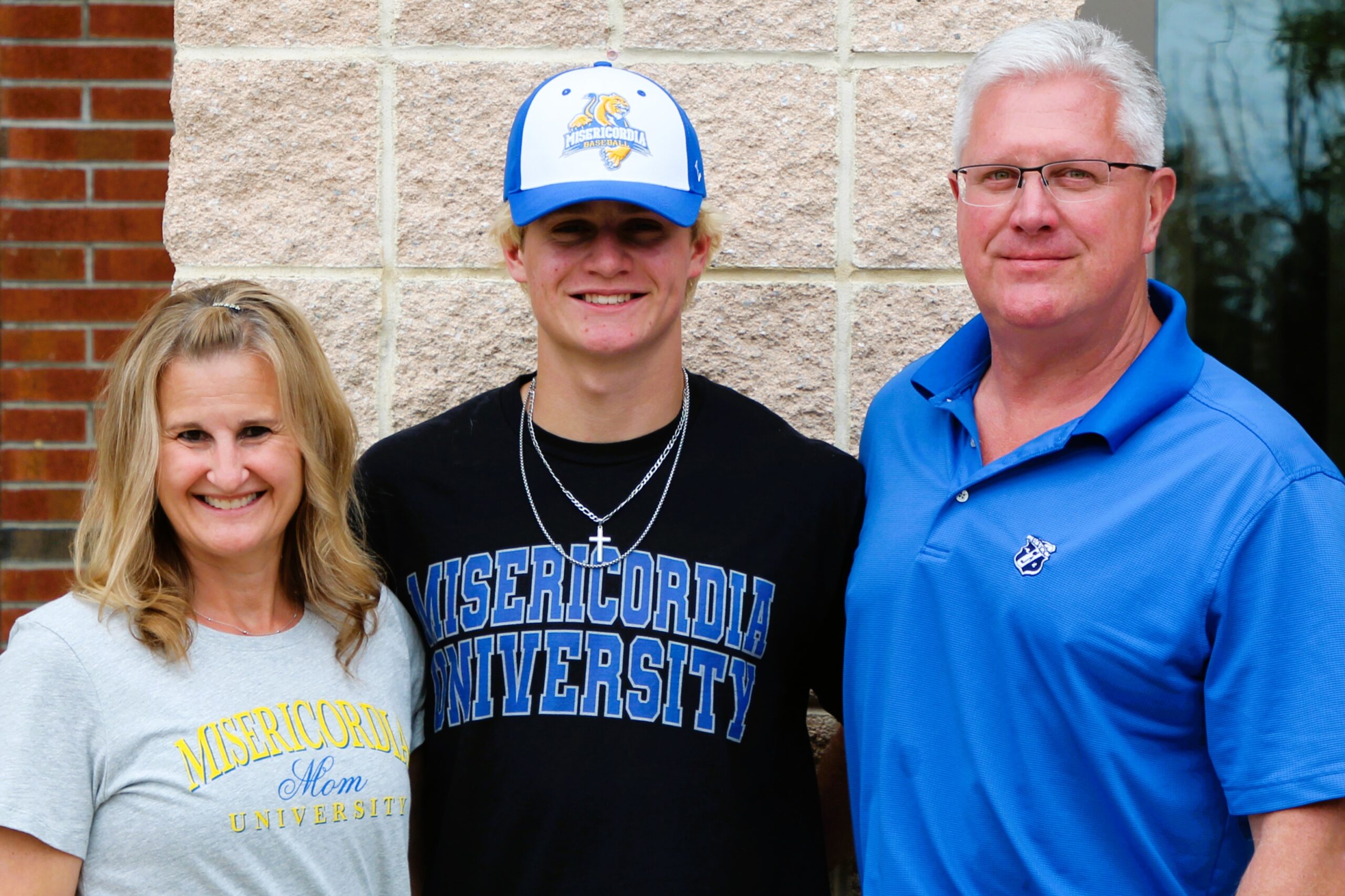 Warwick Valley High School athlete poses with family members after signing a national letters of intent to play sports in college.