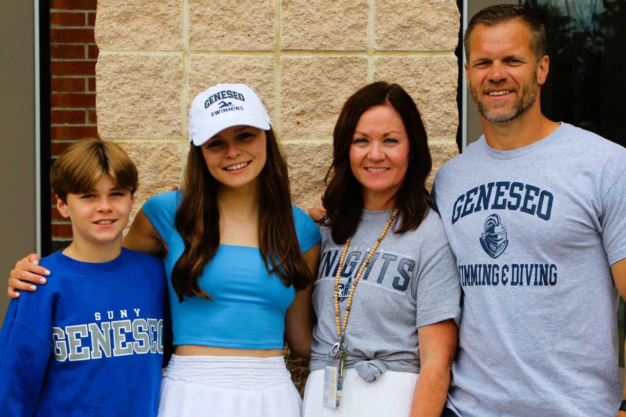 Warwick Valley High School athlete poses with family members after signing a national letters of intent to play sports in college.