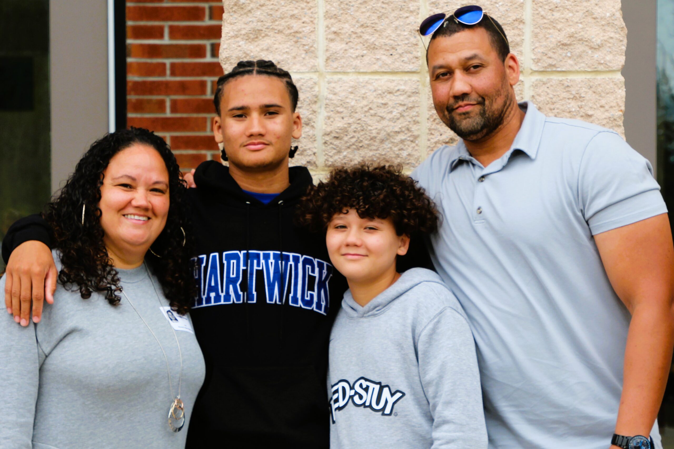 Warwick Valley High School athlete poses with family members after signing a national letters of intent to play sports in college.