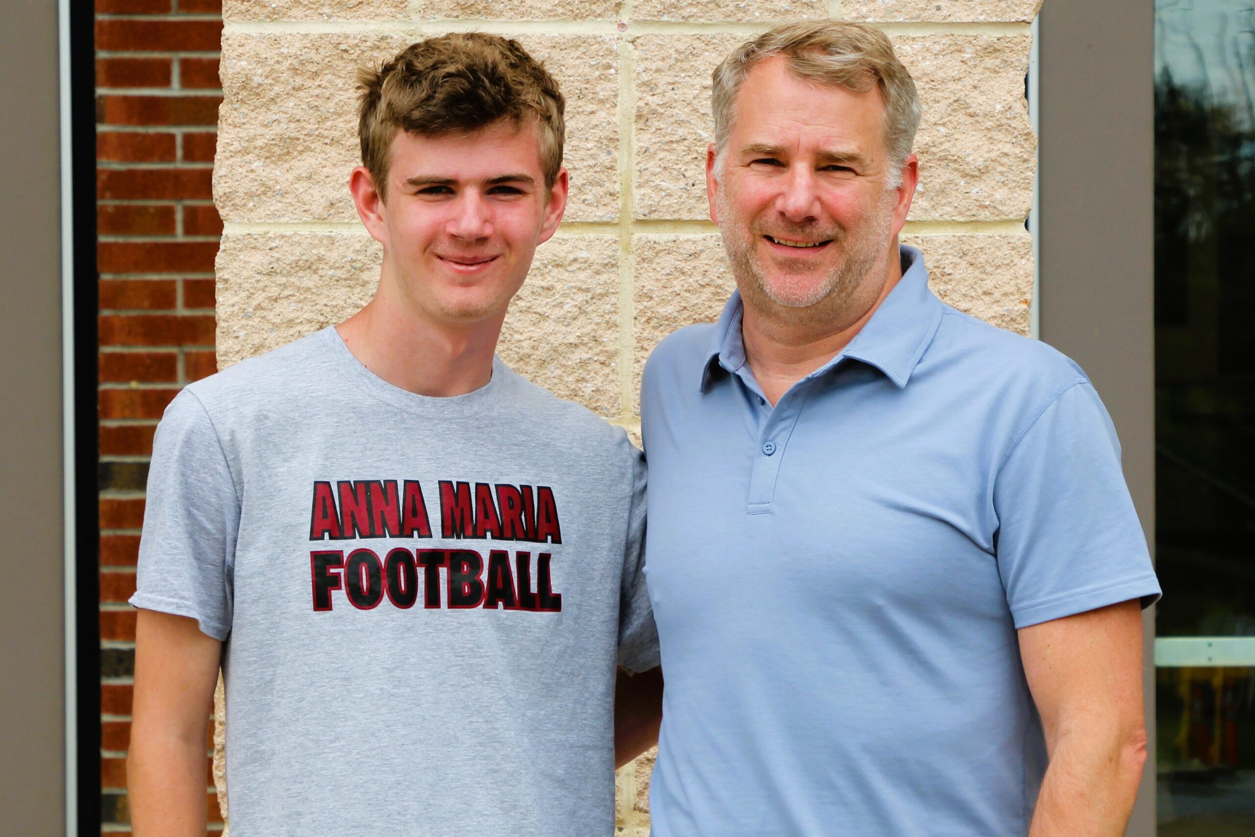 Warwick Valley High School athlete poses with family member after signing a national letters of intent to play sports in college.