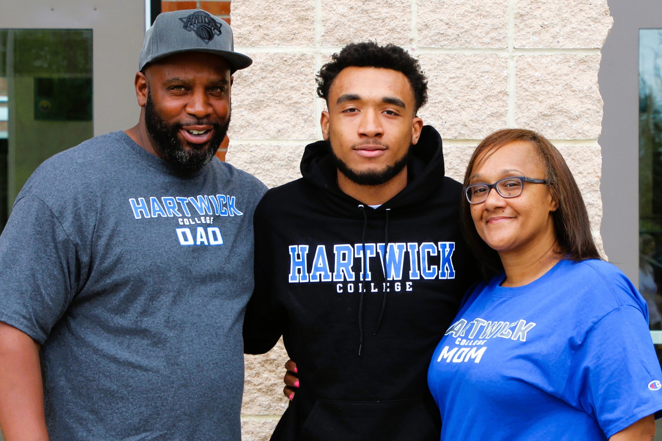 Warwick Valley High School athlete poses with family members after signing a national letters of intent to play sports in college.