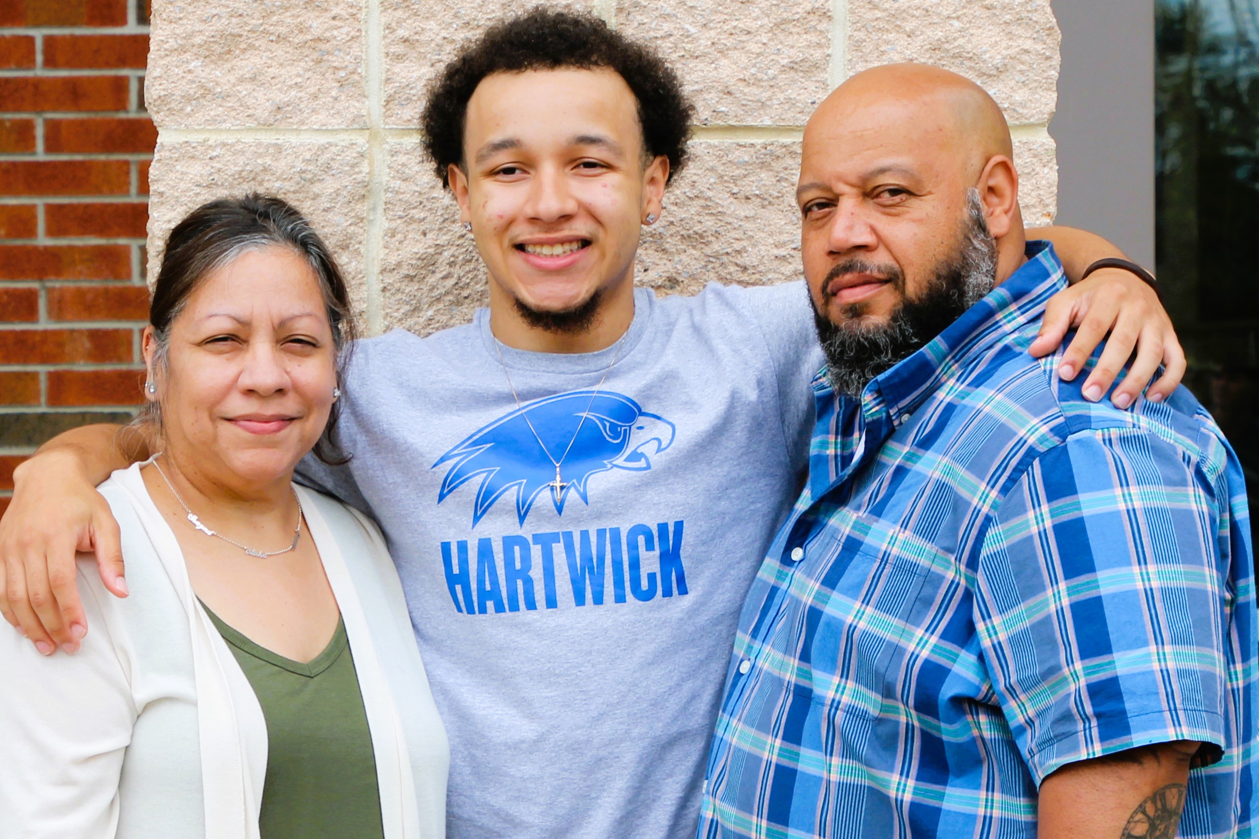 Warwick Valley High School athlete poses with family members after signing a national letters of intent to play sports in college.