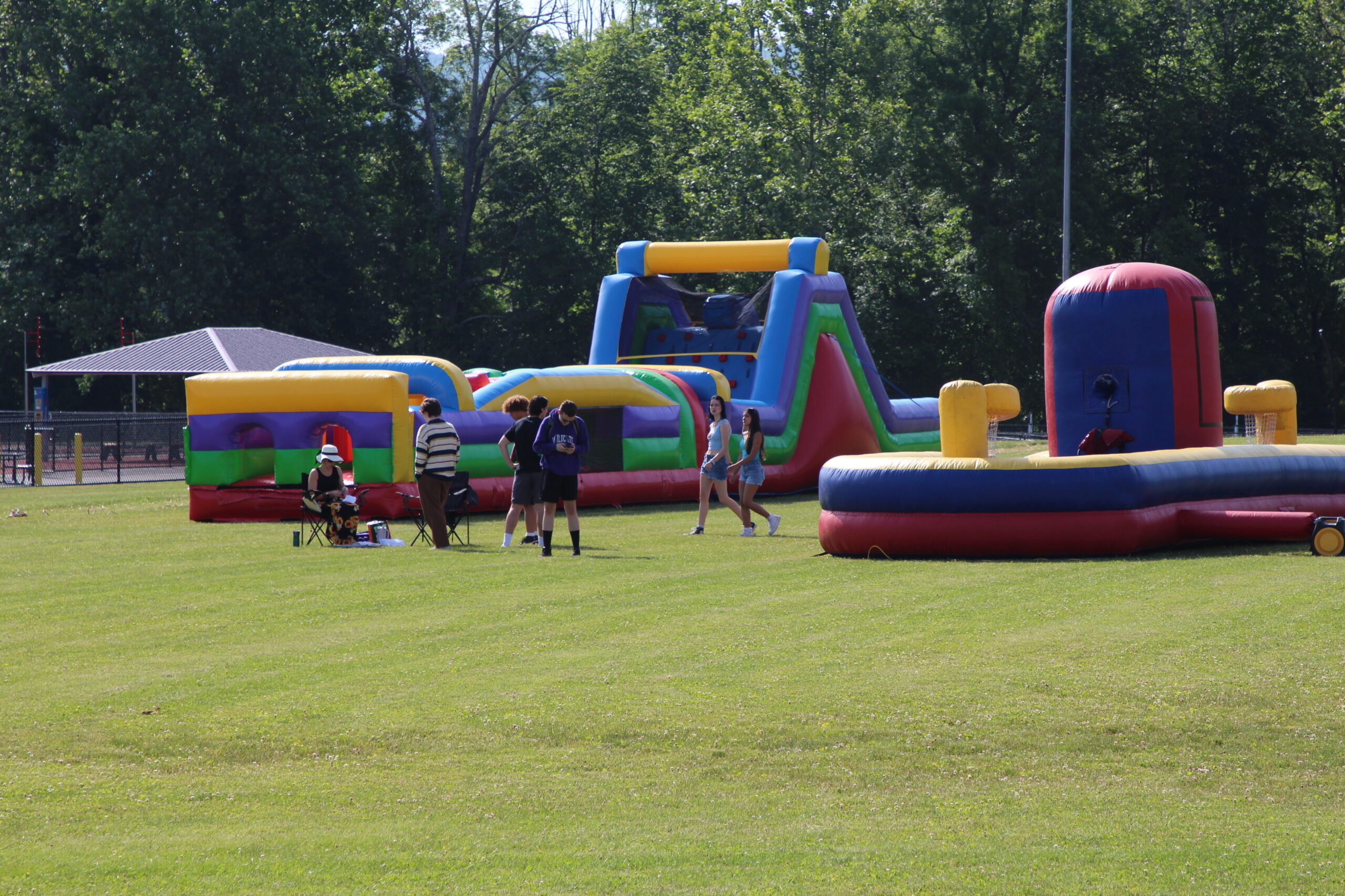 Warwick Valley High School seniors stand by inflatable attractions during their senior picnic