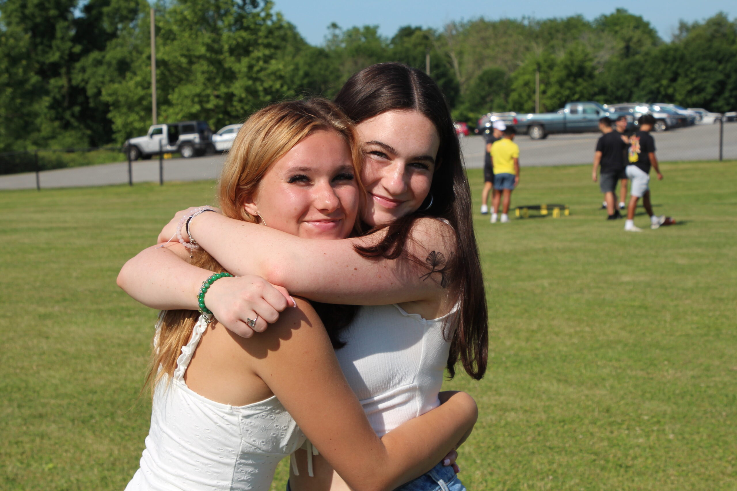 Warwick Valley High School seniors hug and smile at the camera during their Senior Picnic