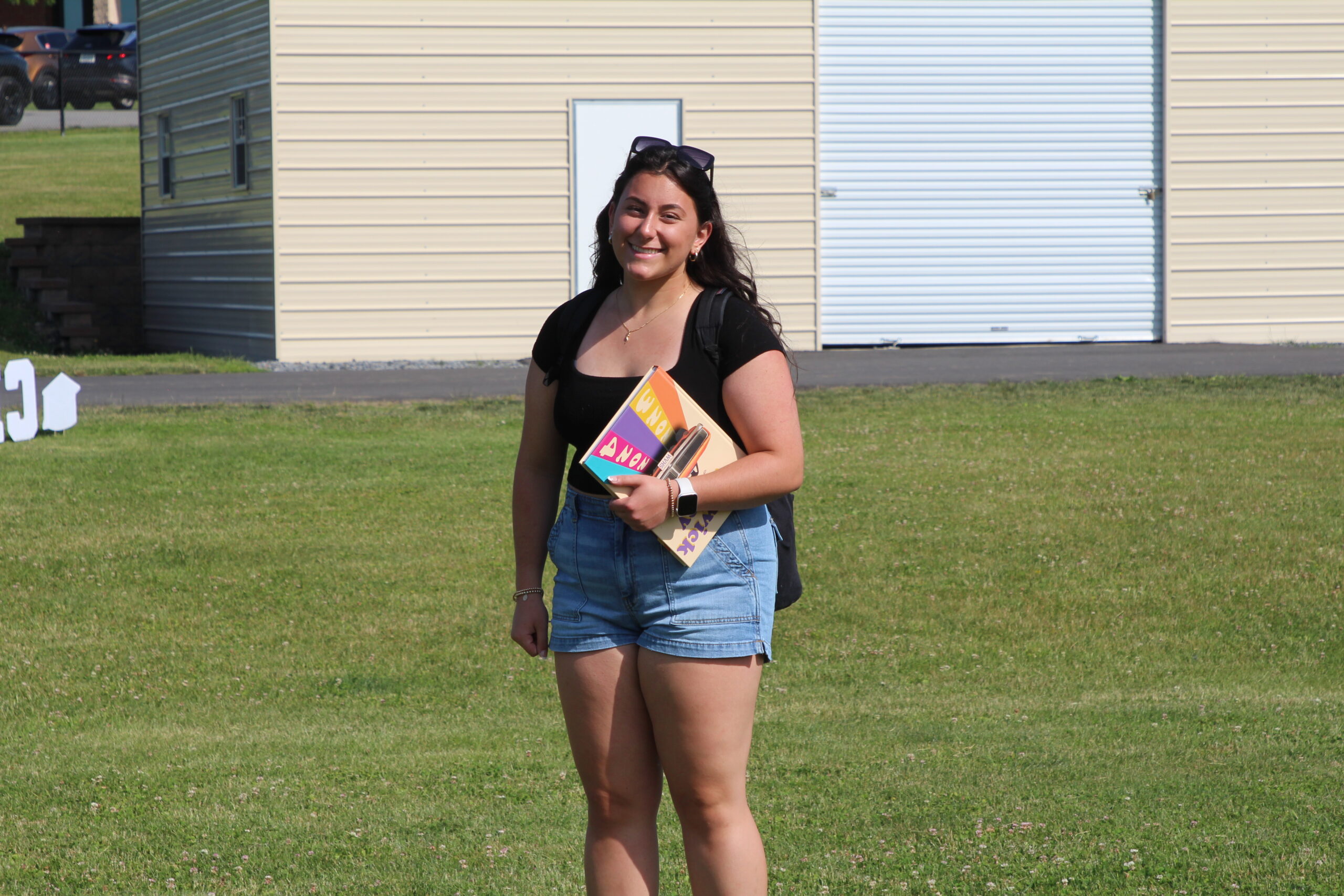 A Warwick Valley High School senior smiles at the camera during the Senior Picnic