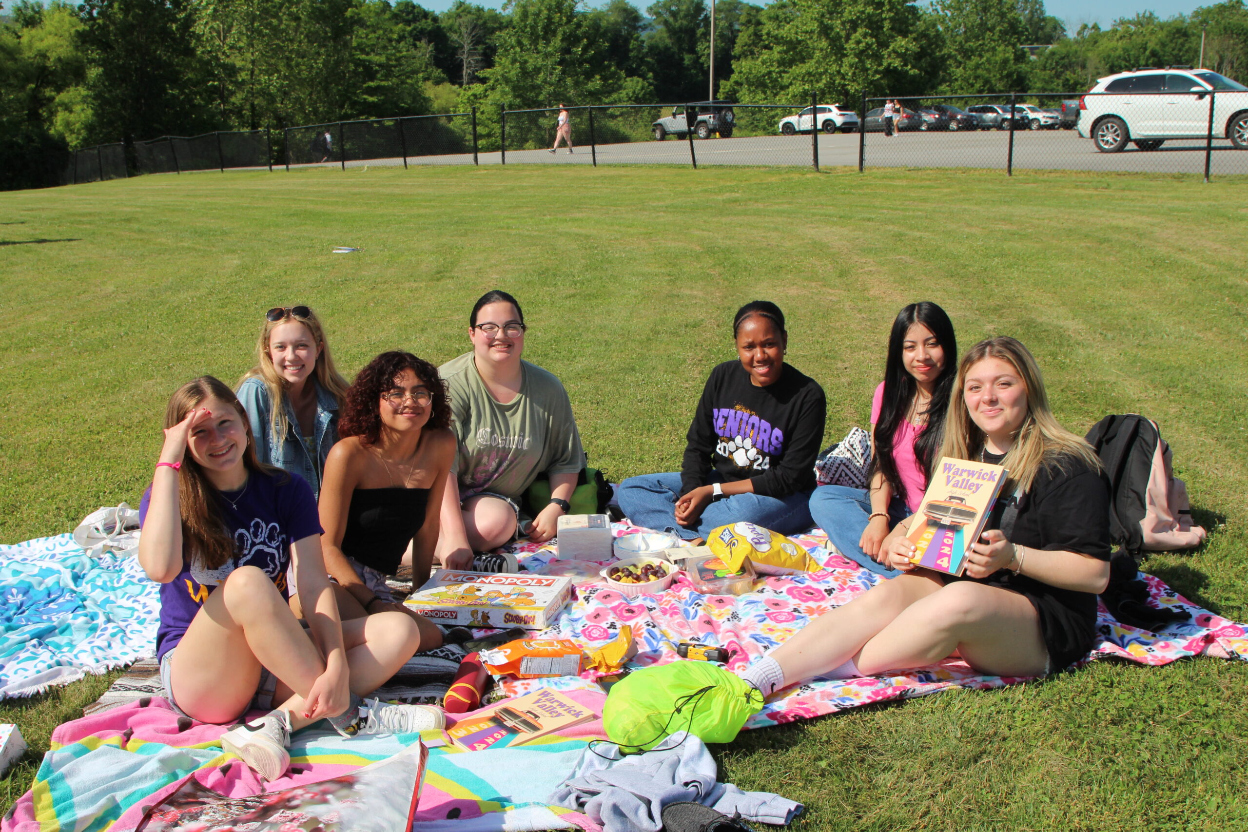 Warwick Valley High School seniors sit on blankets on the grass during their Senior Picnic