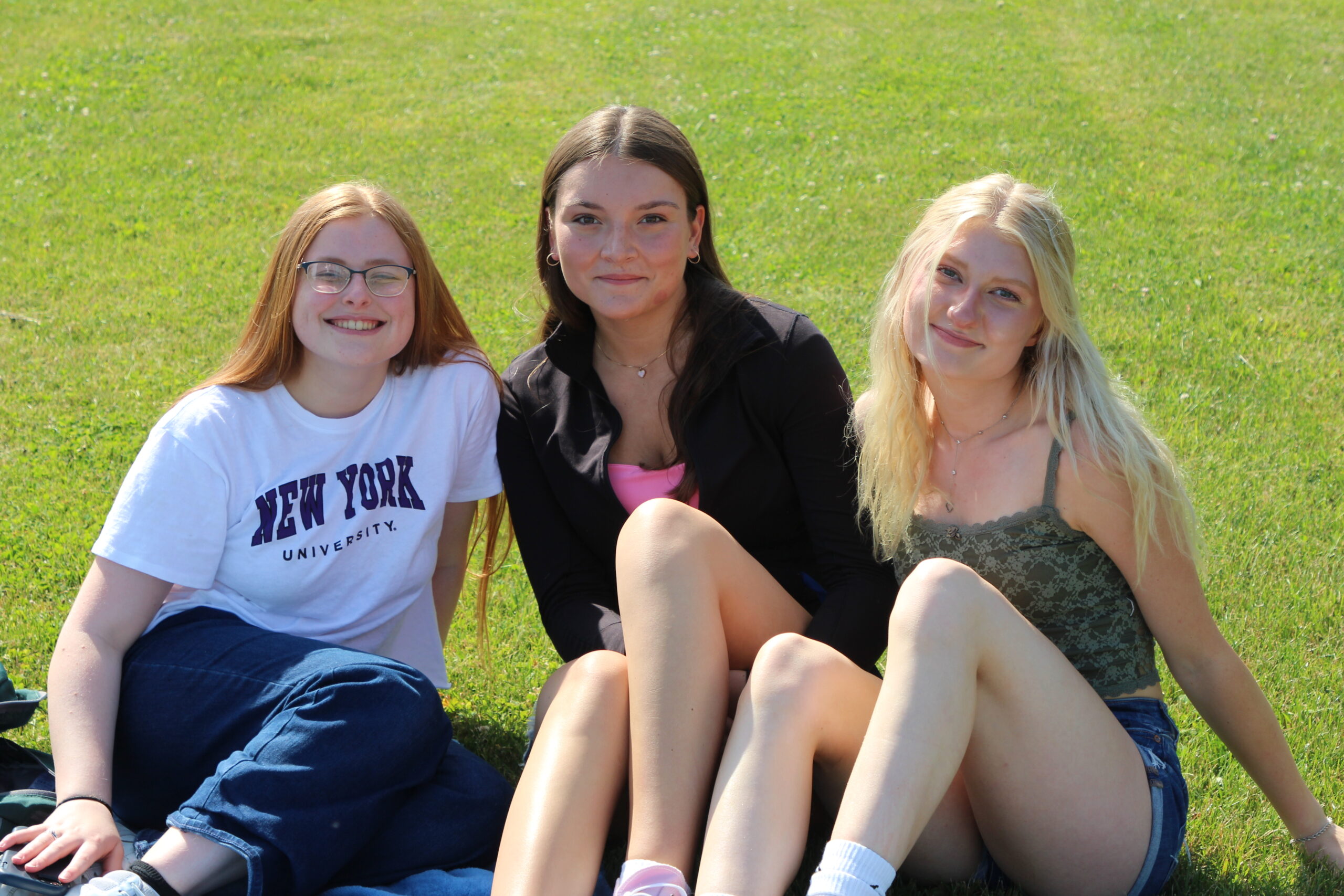 Warwick Valley High School seniors sit on blankets on the grass and smile during their Senior Picnic