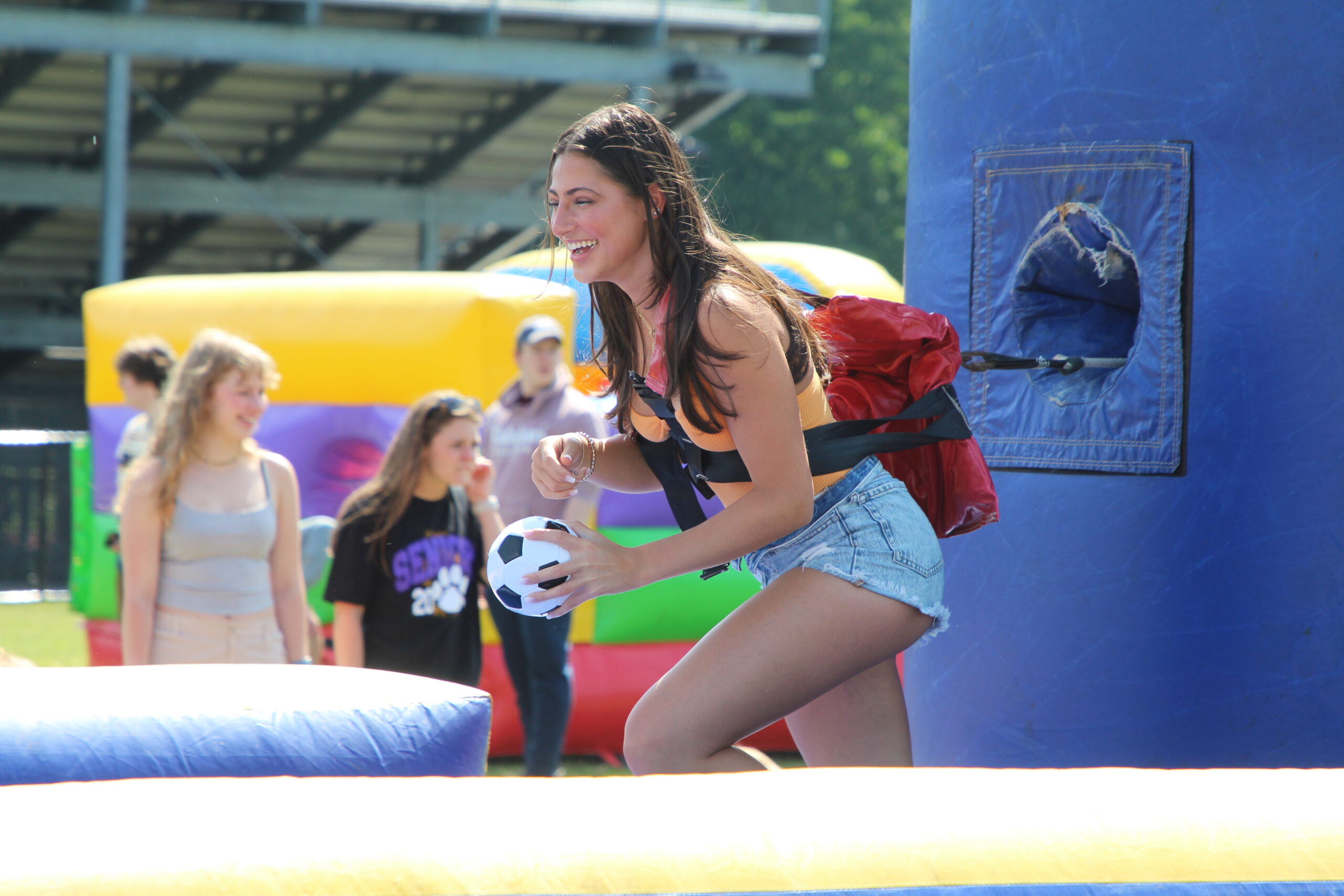 A Warwick Valley High School senior smiles while playing a game during the Senior Picnic