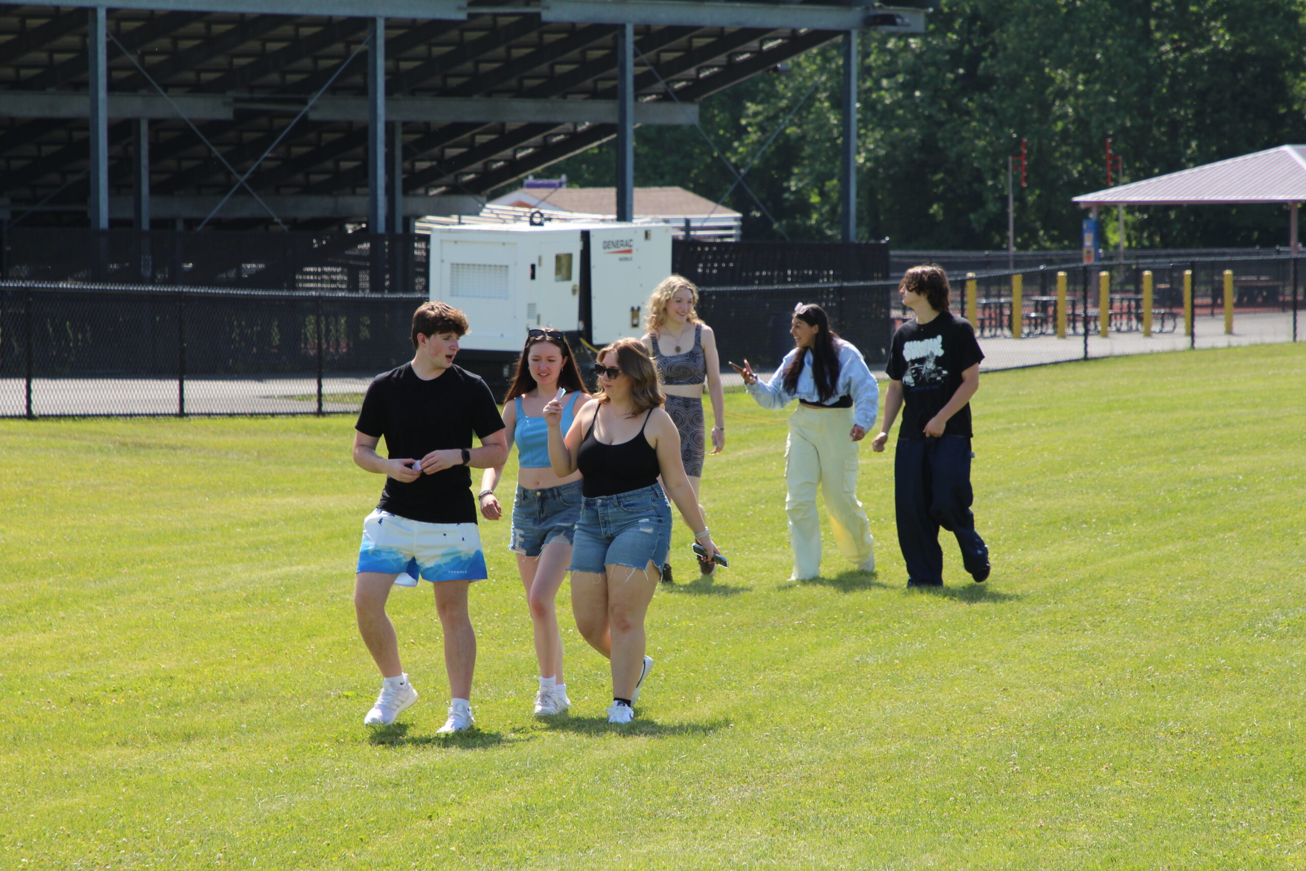 Warwick Valley High School seniors walk across the grass during their Senior Picnic