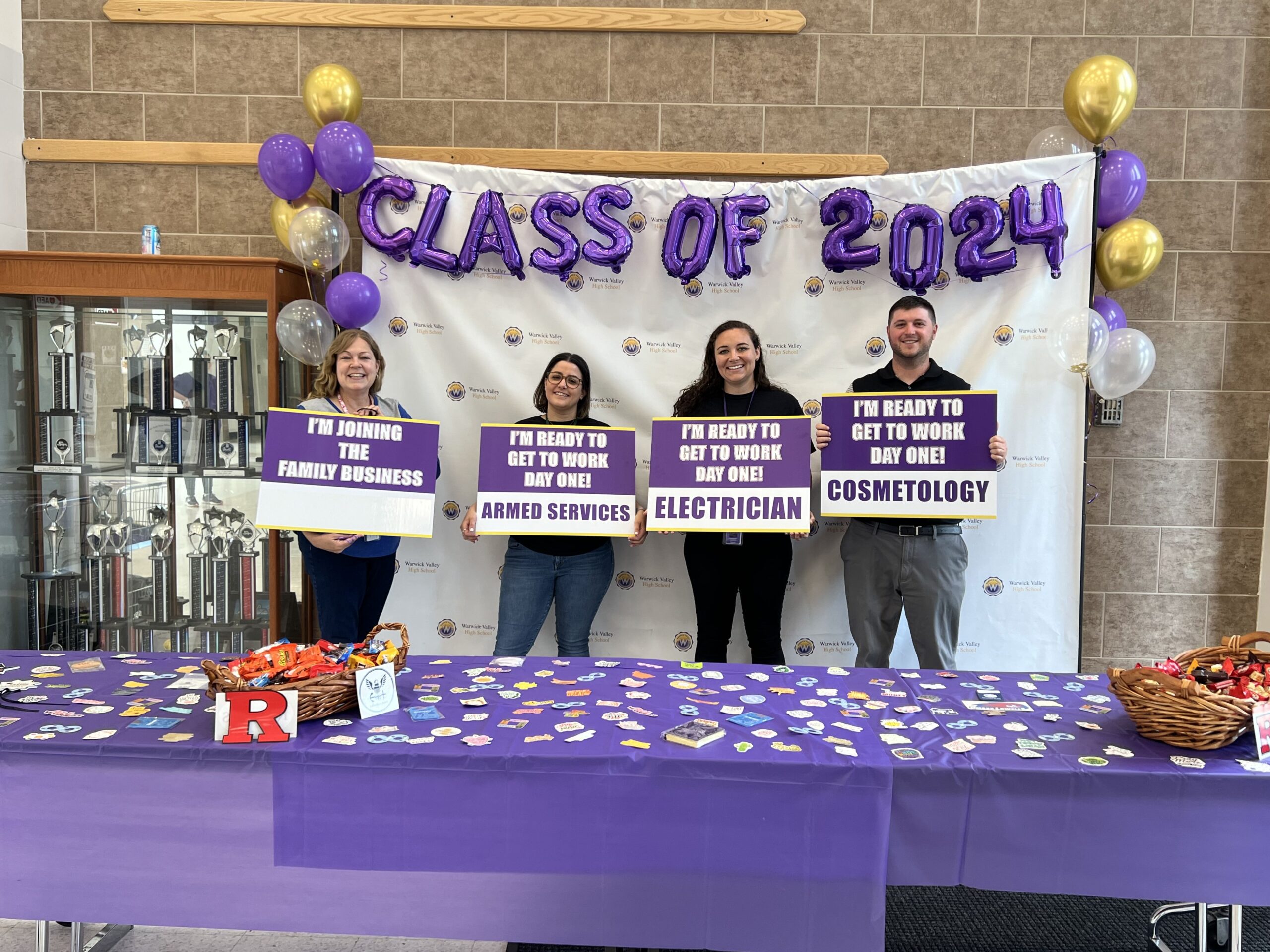 WVHS guidance counselors hold signs on Decision Day, celebrating the Class of 2024 and the choices they’ve made about their post high school lives.