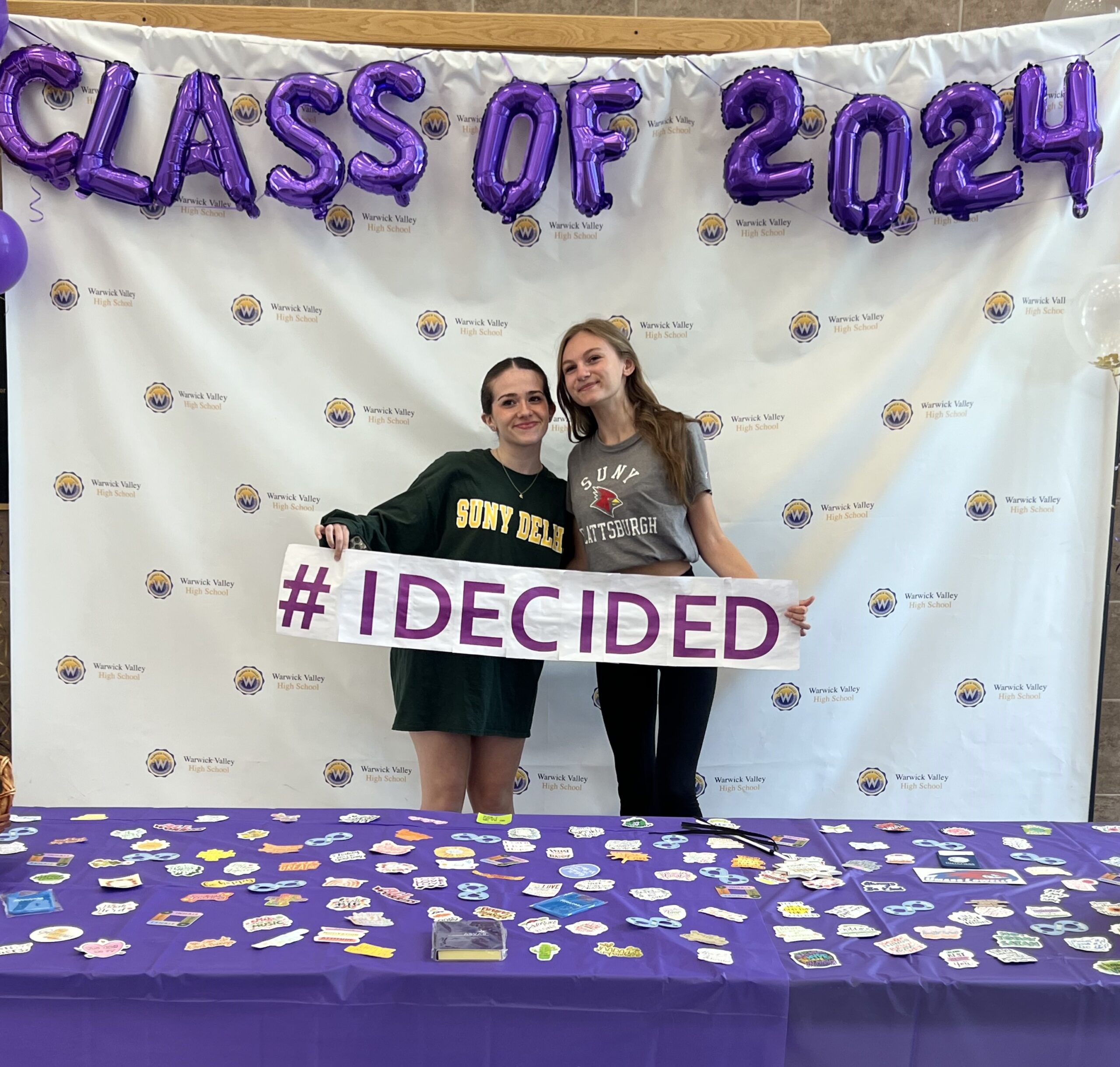 Two WVHS seniors hold an "I DECIDED" banner on Decision Day, celebrating the Class of 2024 and the choices they’ve made about their post high school lives.